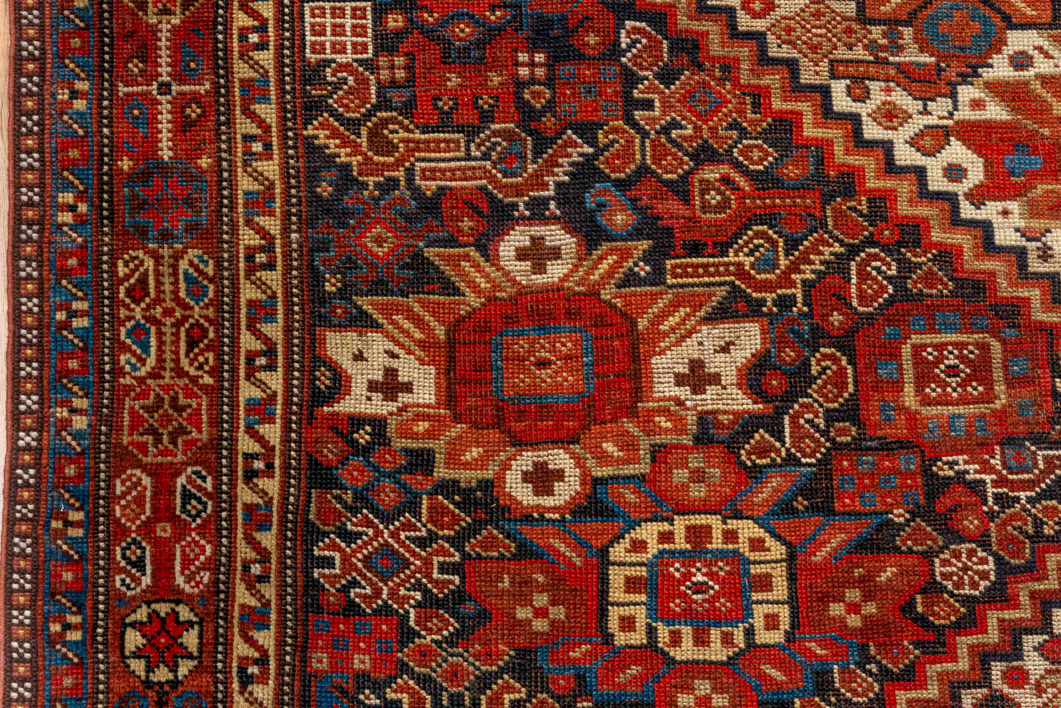 7' x 9' one-of-a-kind handmade vintage Tulu large size rug. Color palette: rust, ivory, navy, crimson, camel, charcoal