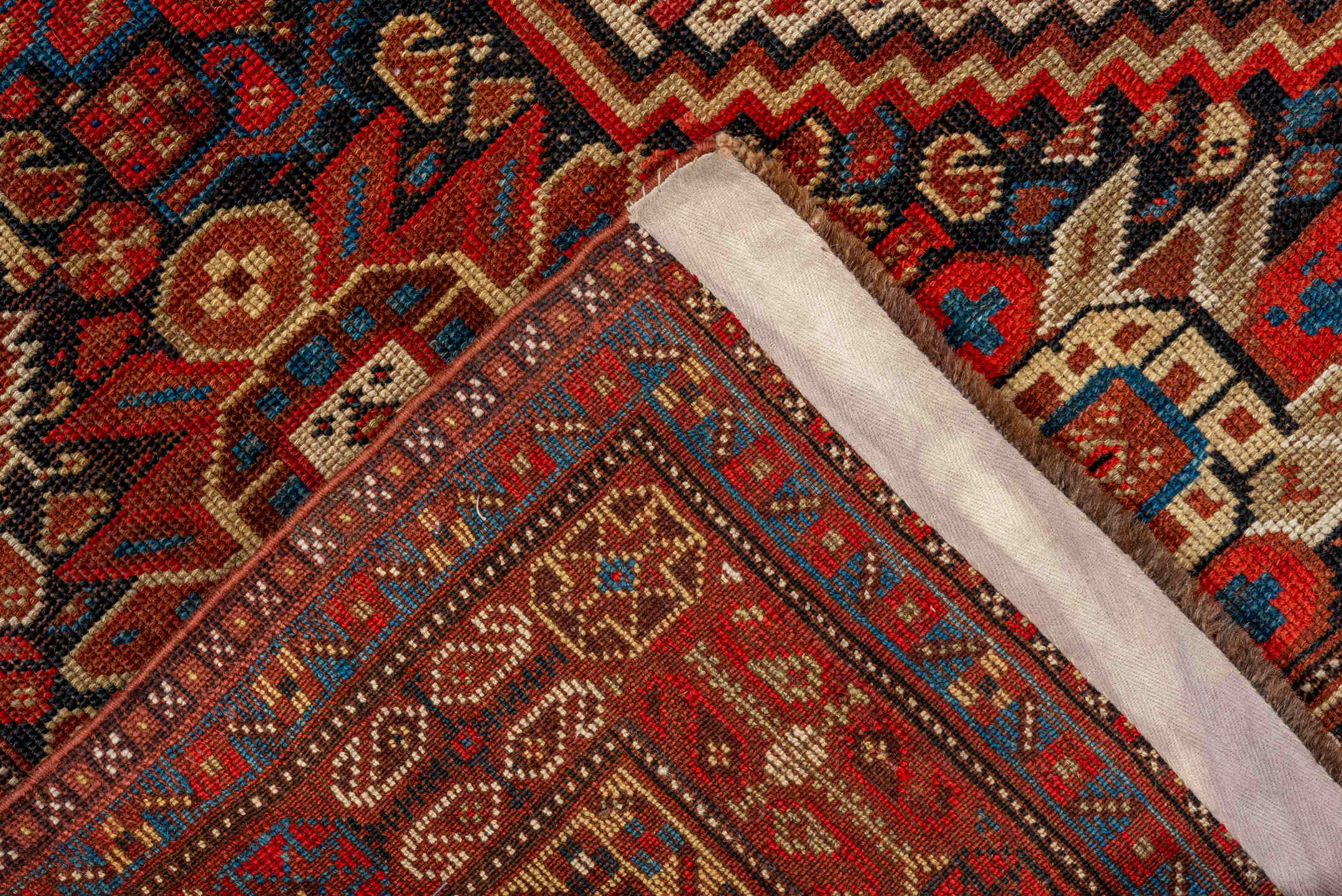 7' x 9' one-of-a-kind handmade vintage Tulu large size rug. Color palette: rust, ivory, navy, crimson, camel, charcoal