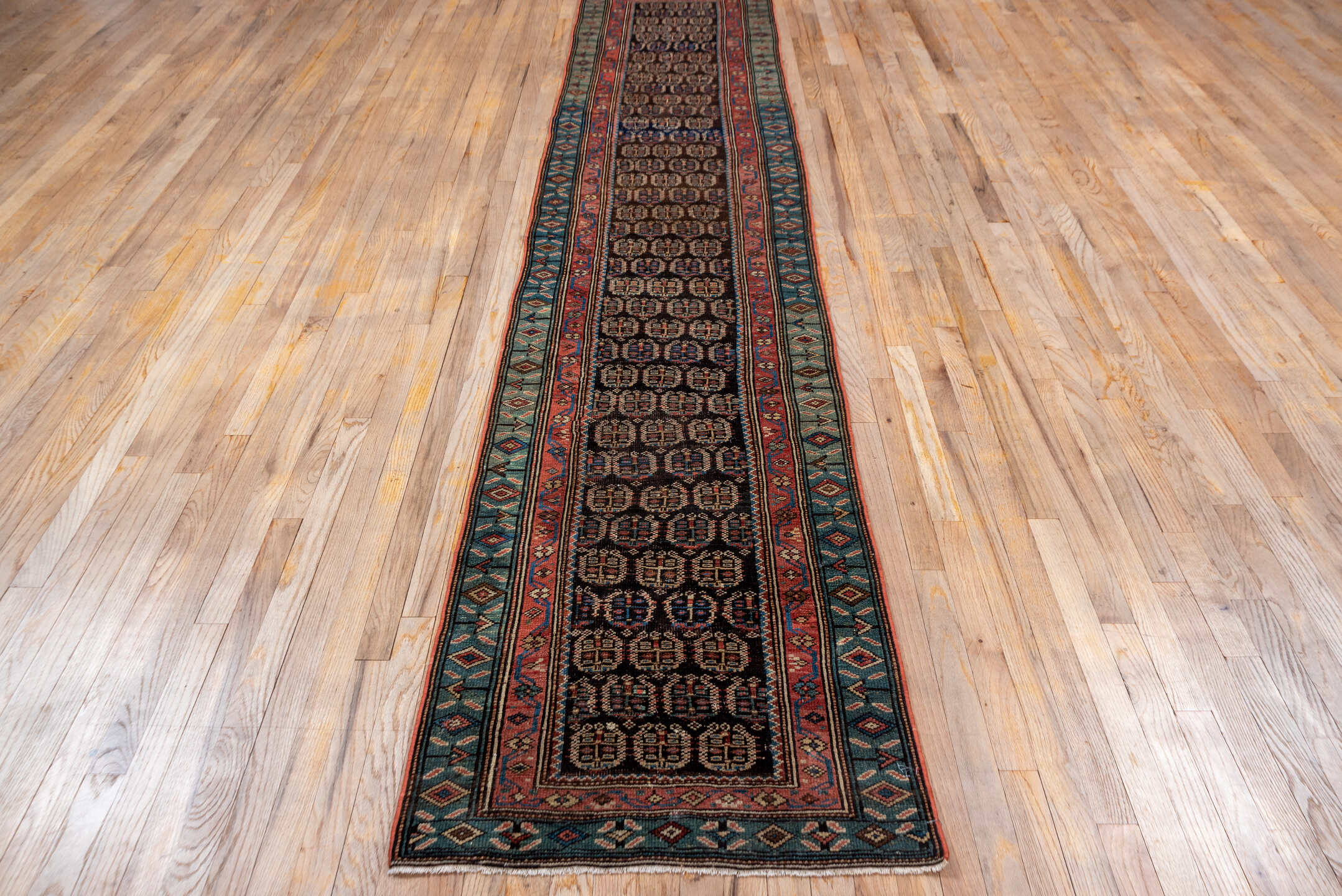 2' x 12' one-of-a-kind handmade vintage Caucasian runner rug. Color palette: black, brown, charcoal, gray, off-white, pink