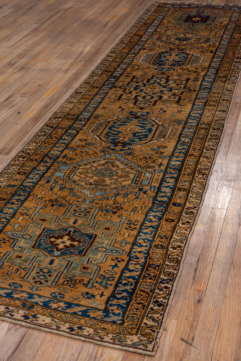 2' x 11' one-of-a-kind handmade vintage Heriz runner rug. Color palette: camel, blue, ivory, rust, taupe, brown, beige