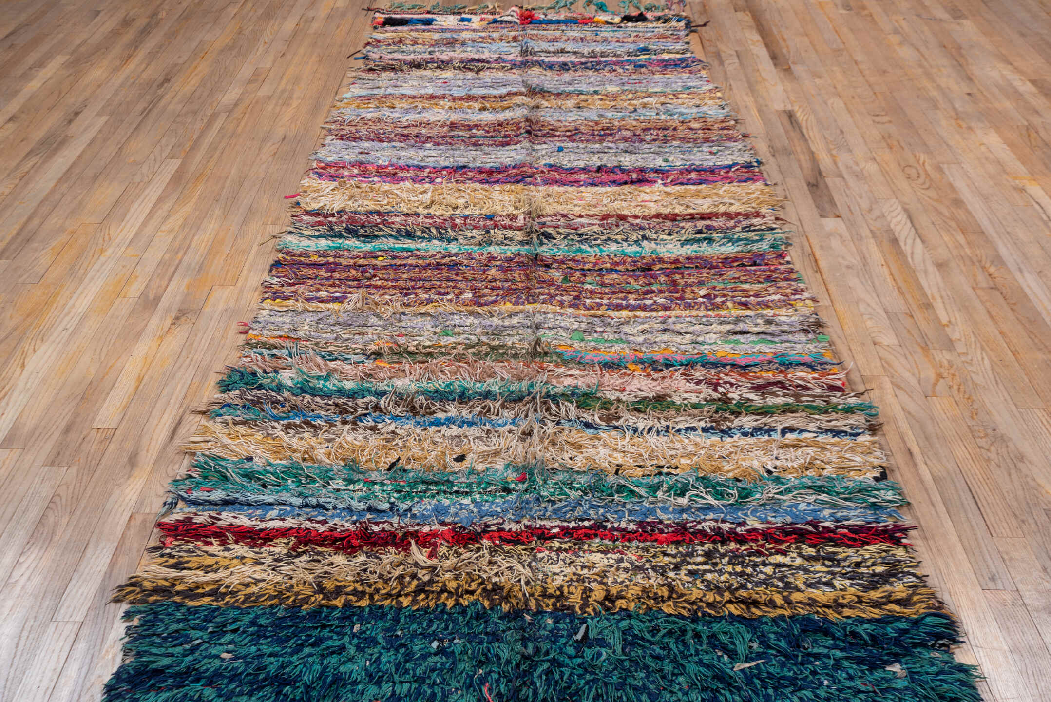 4' x 10' one-of-a-kind handmade vintage Rag Rug runner rug. Color palette: blue, brown, fiord, gray, green, light gray
