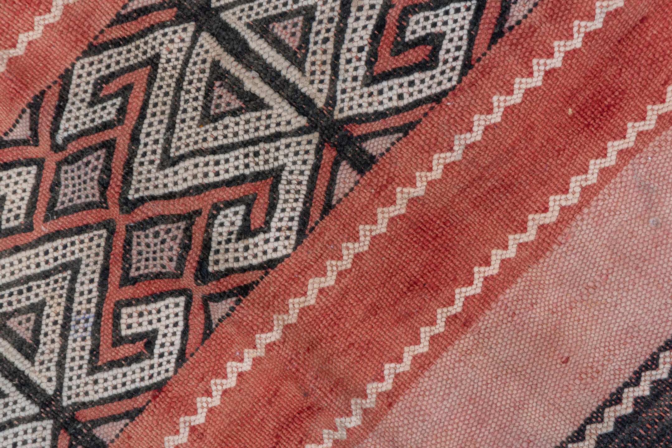 5' x 8' one-of-a-kind handmade vintage Jijim medium size rug. Color palette: black, brown, gray, light gray, orange, pink