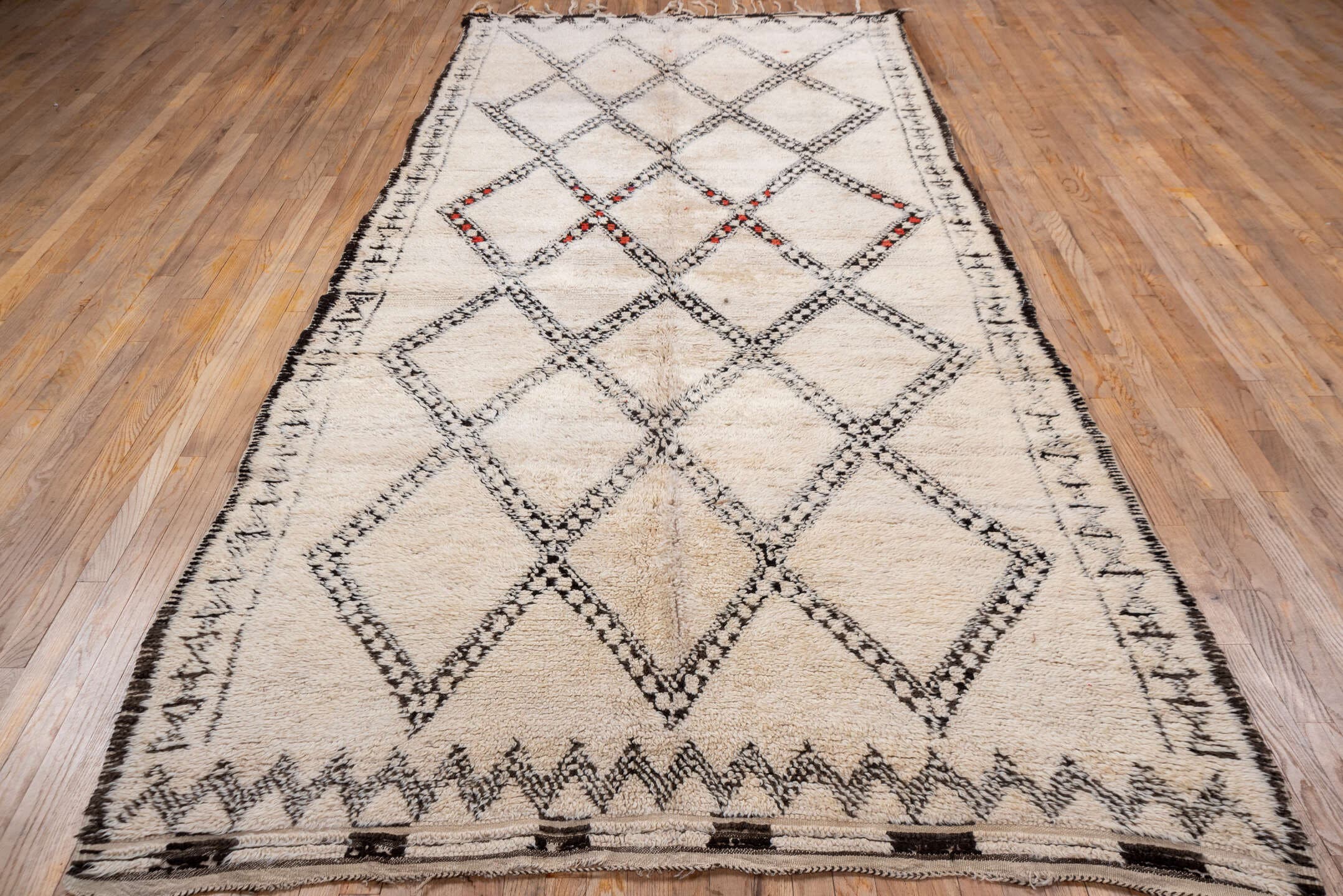 5' x 11' one-of-a-kind handmade vintage Moroccan rug. Color palette: ivory, charcoal, cream, red, gray, black