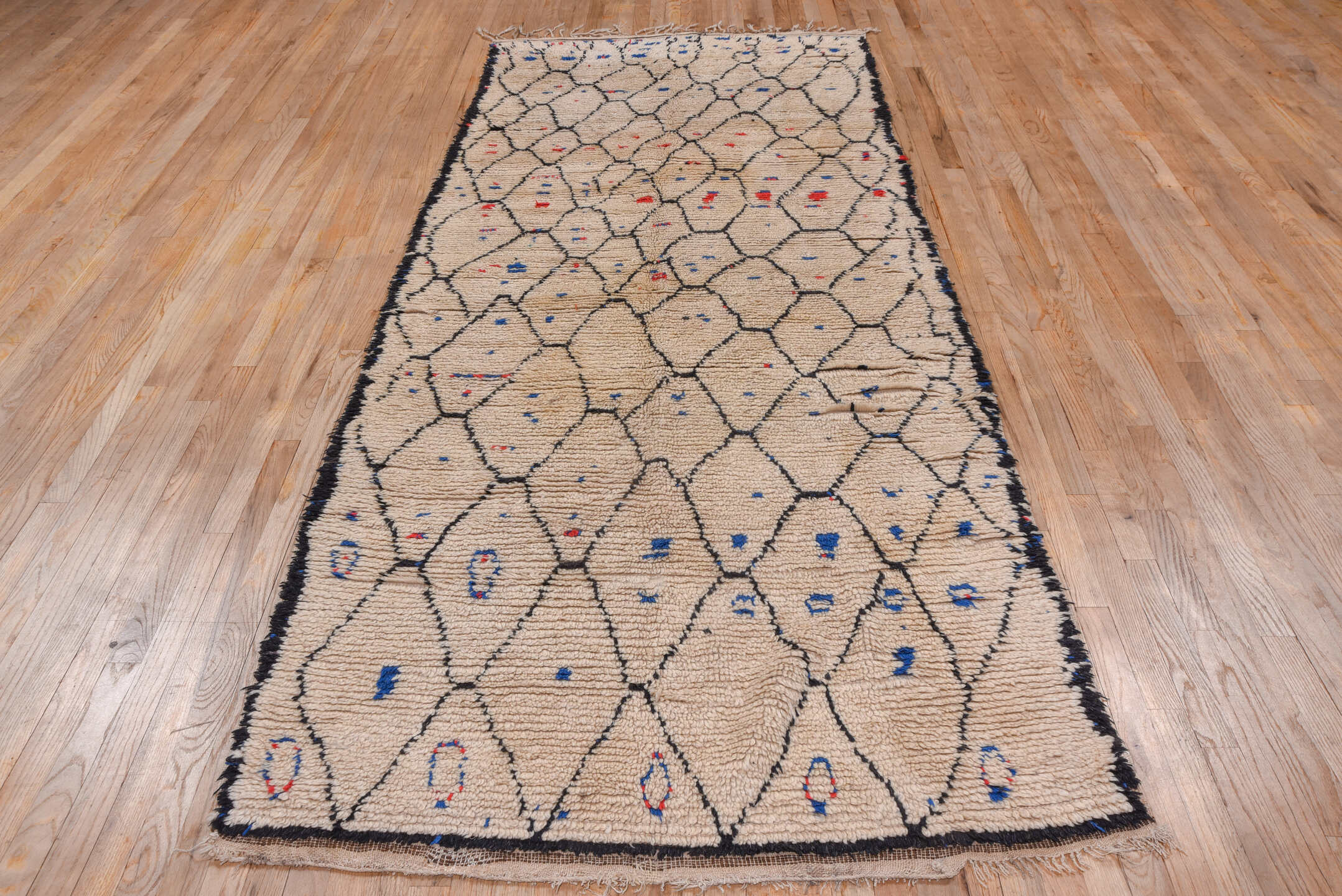 4' x 9' one-of-a-kind handmade vintage Moroccan runner rug. Color palette: ivory, charcoal, cobalt, crimson, gray, black