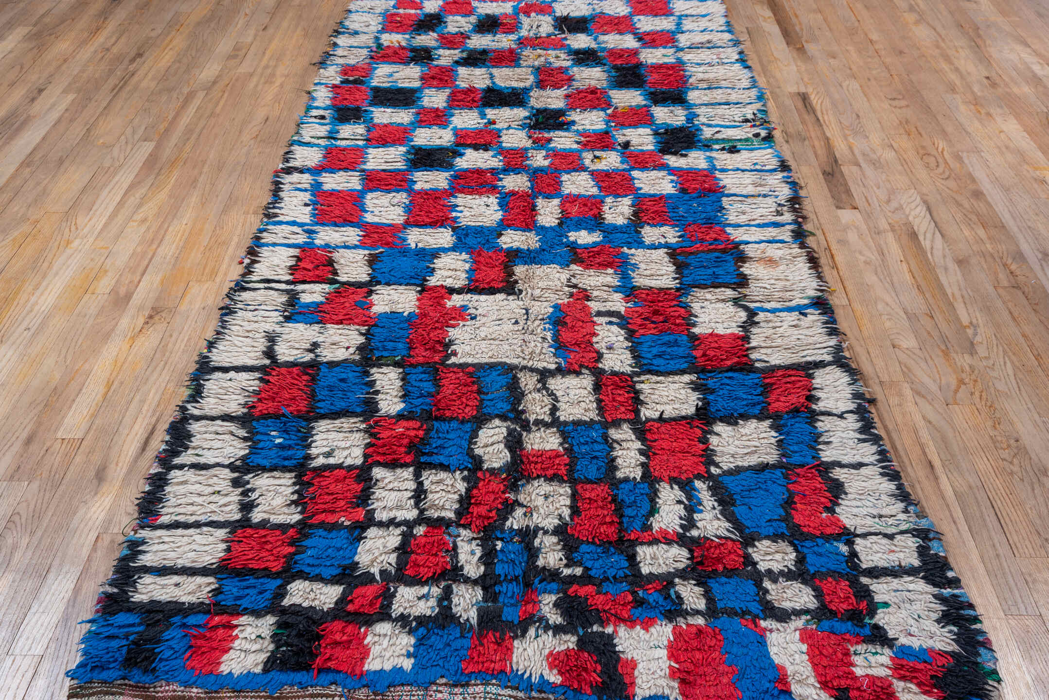4' x 10' one-of-a-kind handmade vintage Moroccan runner rug. Color palette: ivory, cobalt, crimson, black, blue, red