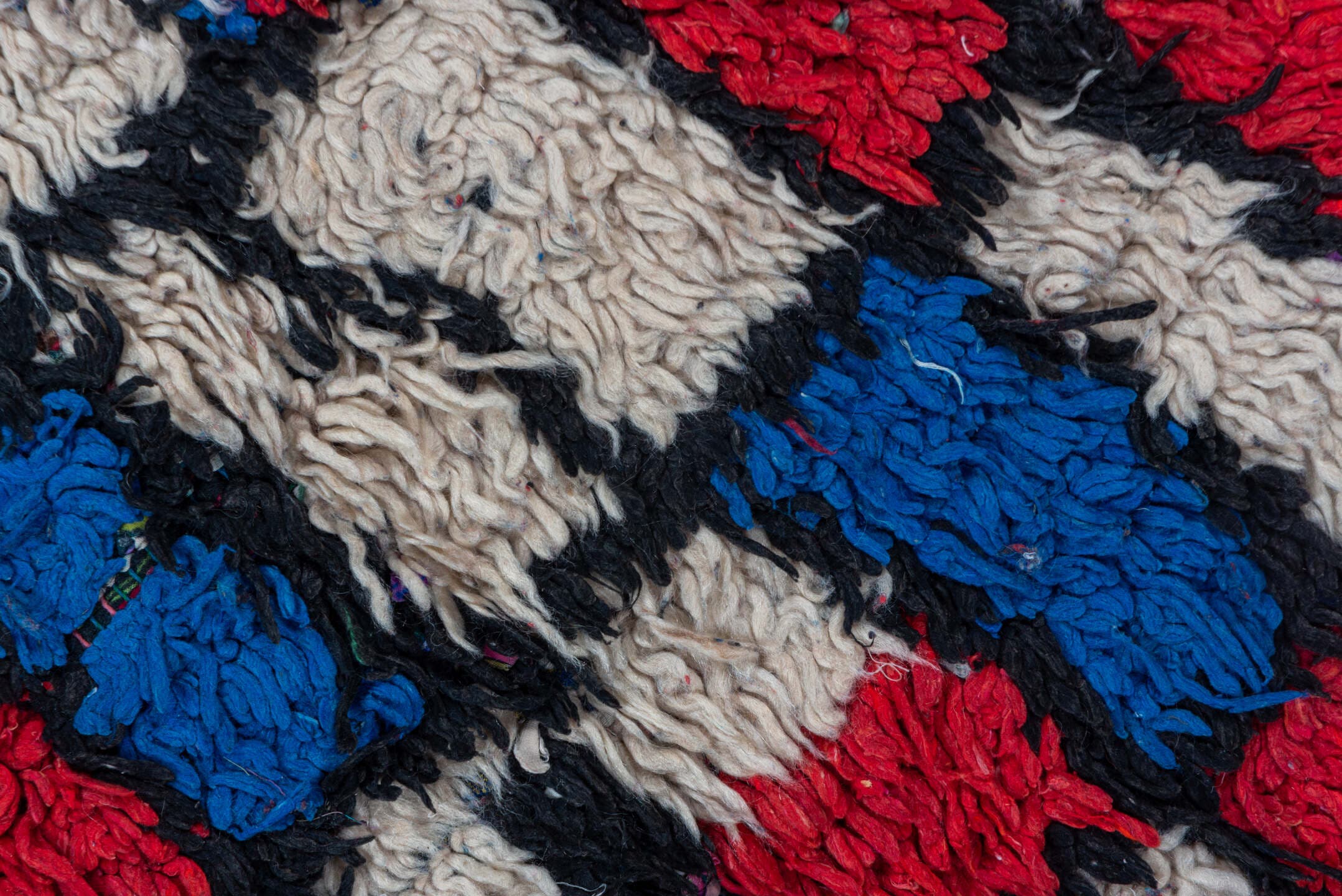 4' x 10' one-of-a-kind handmade vintage Moroccan runner rug. Color palette: ivory, cobalt, crimson, black, blue, red