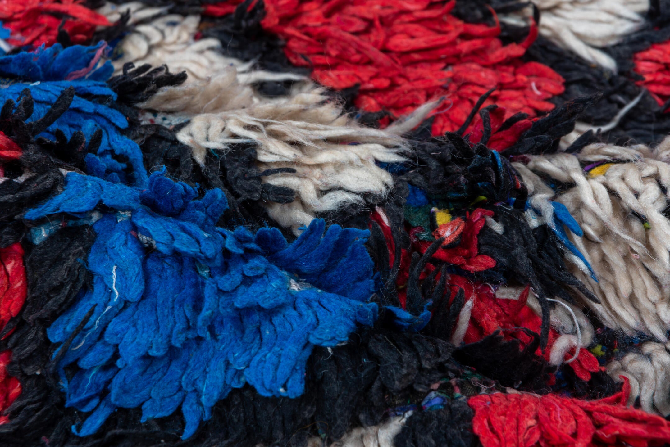 4' x 10' one-of-a-kind handmade vintage Moroccan runner rug. Color palette: ivory, cobalt, crimson, black, blue, red