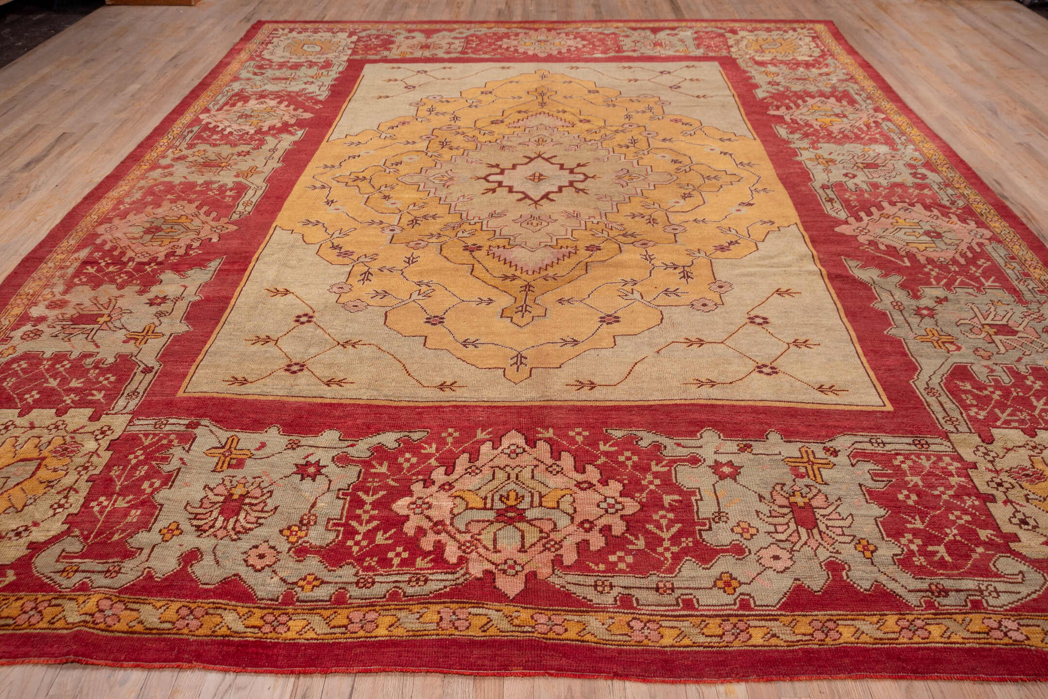 11' x 14' one-of-a-kind handmade antique Oushak oversize rug. Color palette: rust, ivory, gold, peach, sage, rose, taupe
