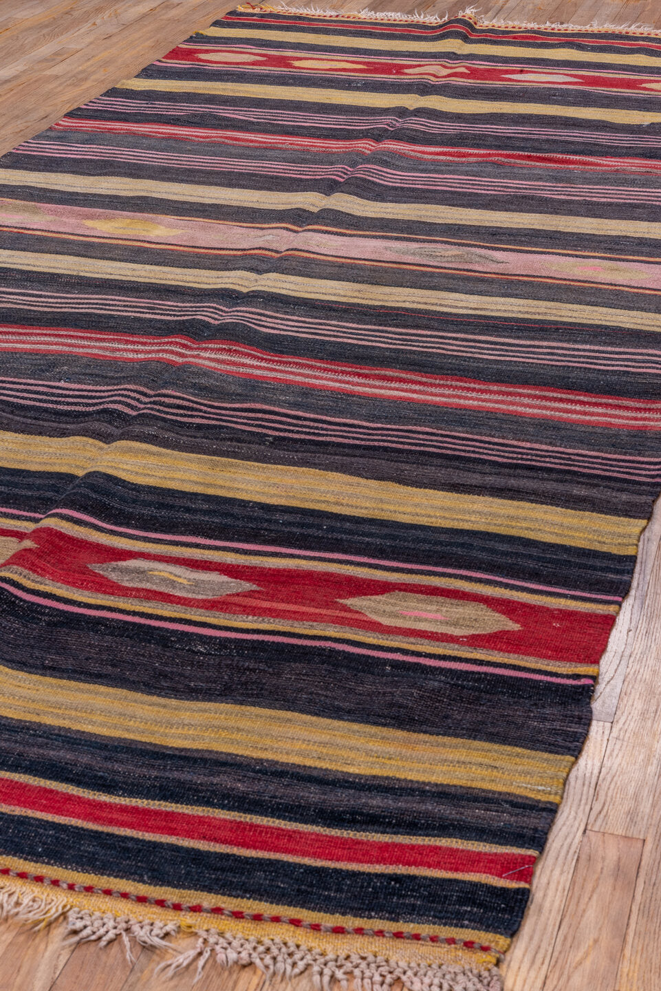 4' x 11' one-of-a-kind handmade vintage Kilim runner rug. Color palette: black, brown, charcoal, gray, pink, red