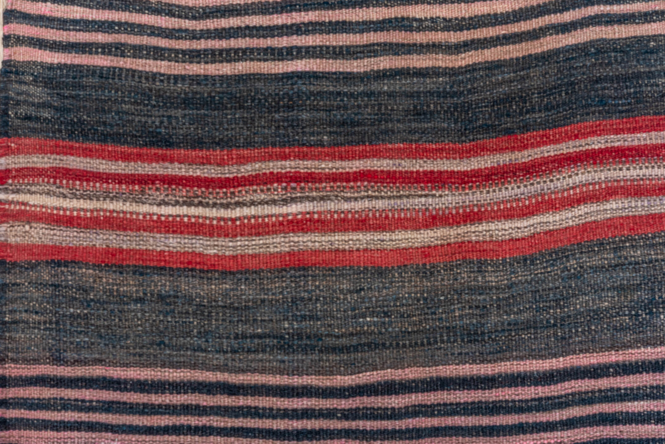 4' x 11' one-of-a-kind handmade vintage Kilim runner rug. Color palette: black, brown, charcoal, gray, pink, red