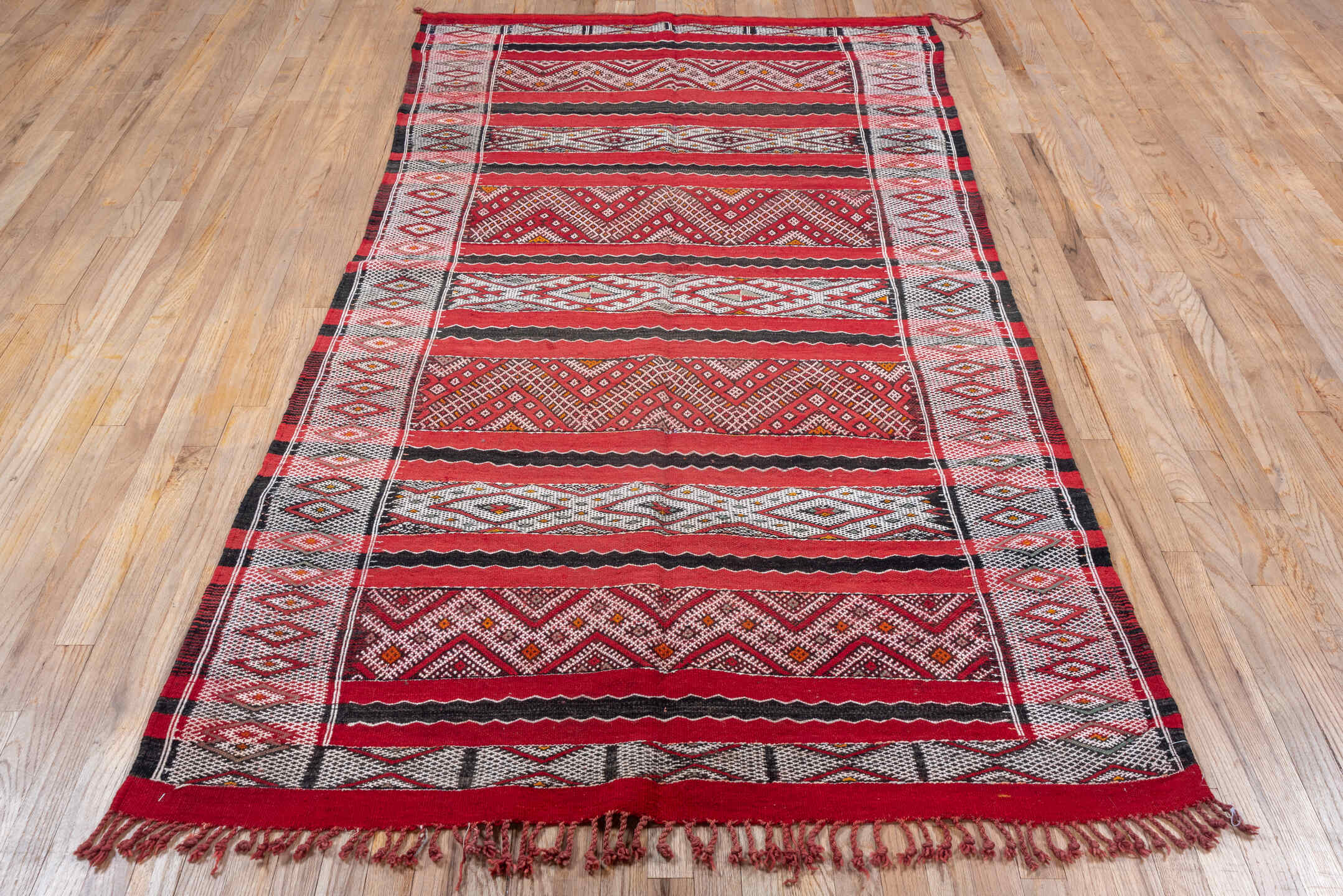 4' x 8' one-of-a-kind handmade vintage Kilim rug. Color palette: red, ivory, charcoal, rust, brown, gray, black, terracotta