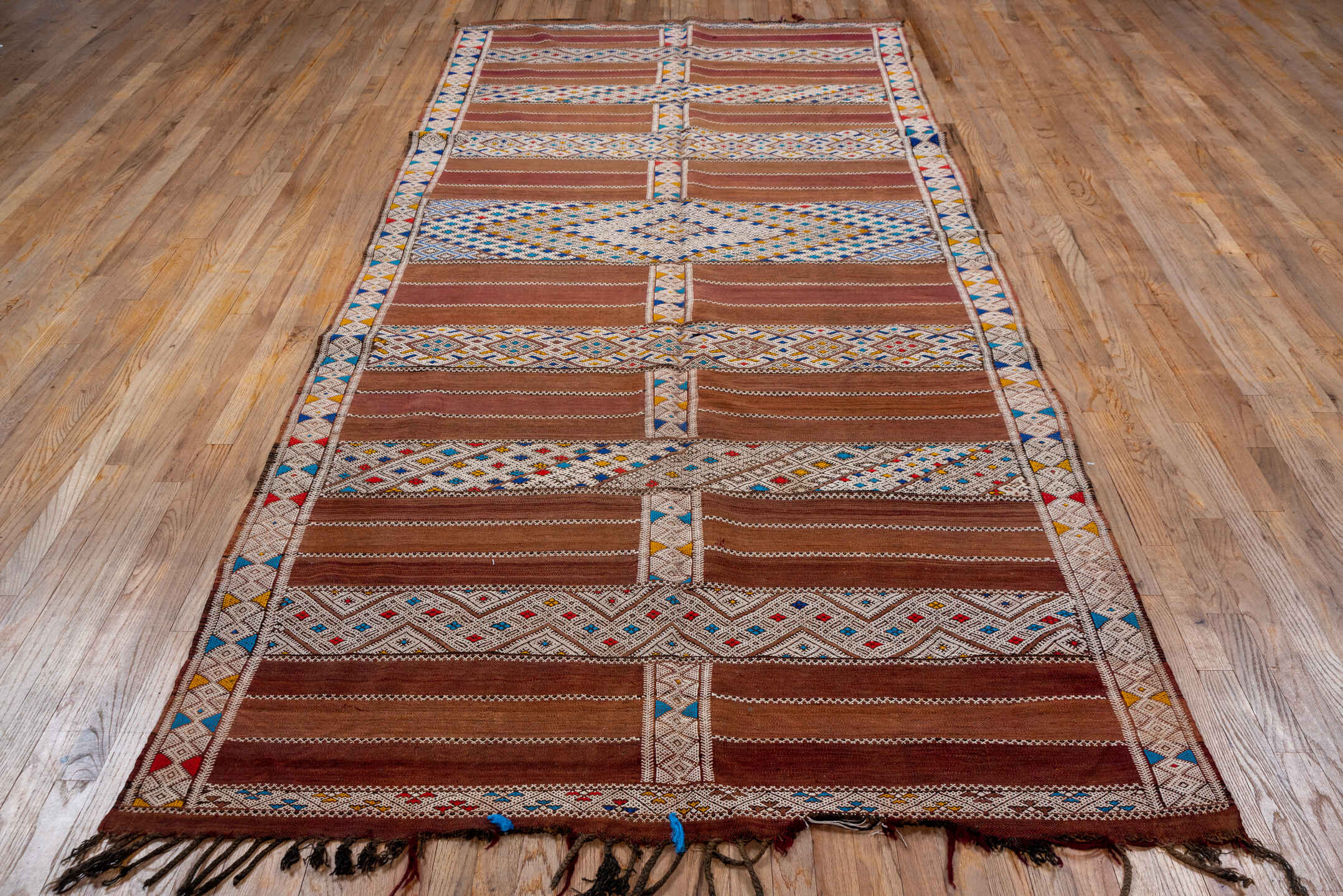 5' x 11' one-of-a-kind handmade vintage Kilim rug. Color palette: camel, ivory, indigo, rust, saffron, terra cotta, sky blue