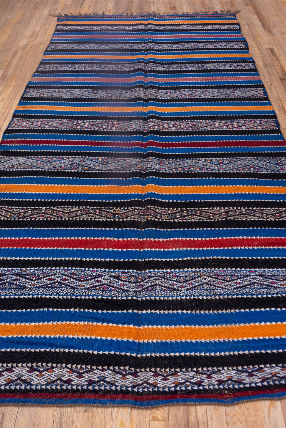5' x 11' one-of-a-kind handmade vintage Kilim rug. Color palette: indigo, ivory, charcoal, rust, burgundy, blue, purple