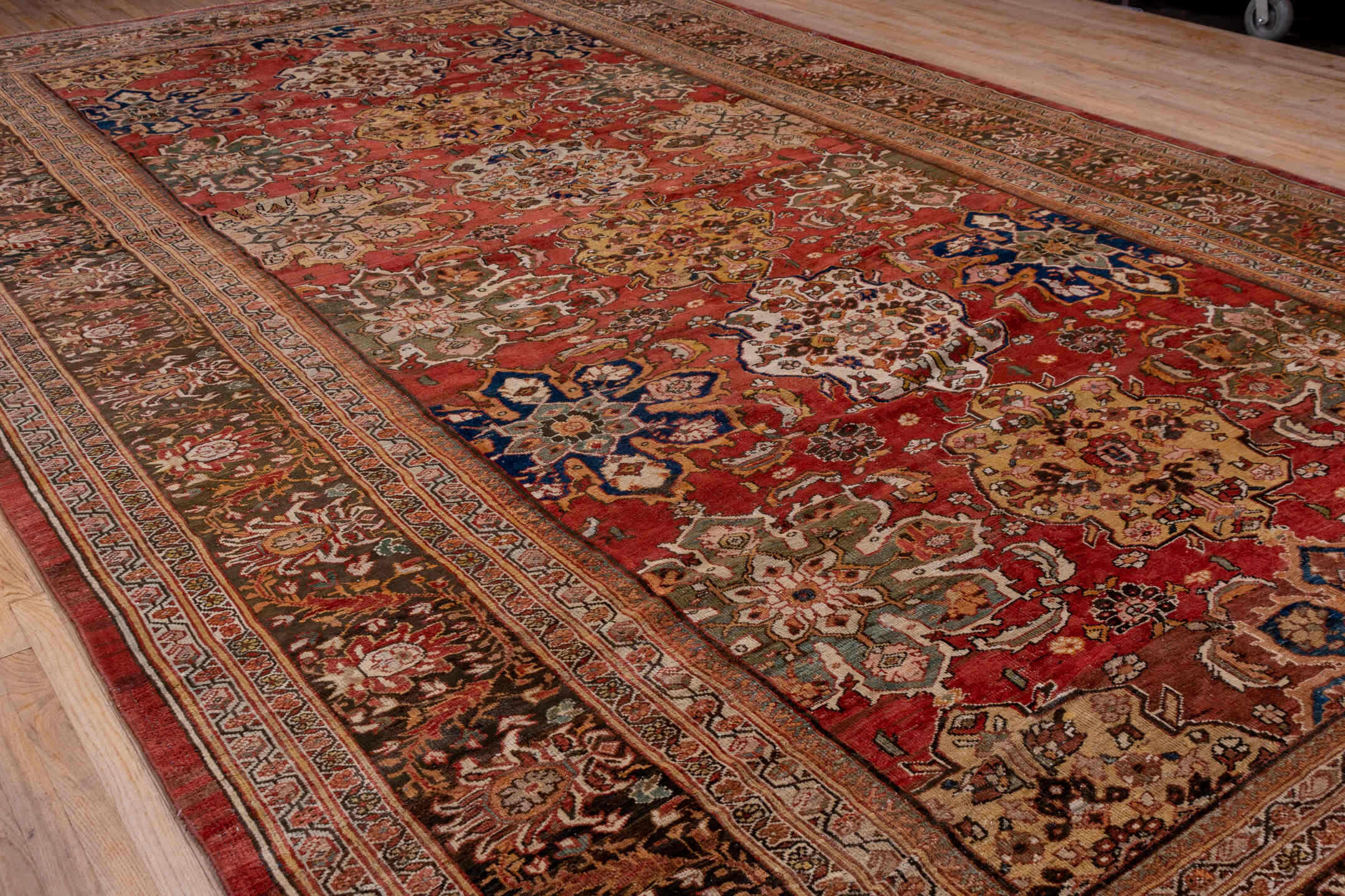 11' x 19' one-of-a-kind handmade antique Sultanabad oversize rug. Color palette: terra cotta, brown, ivory, gold, navy, sage