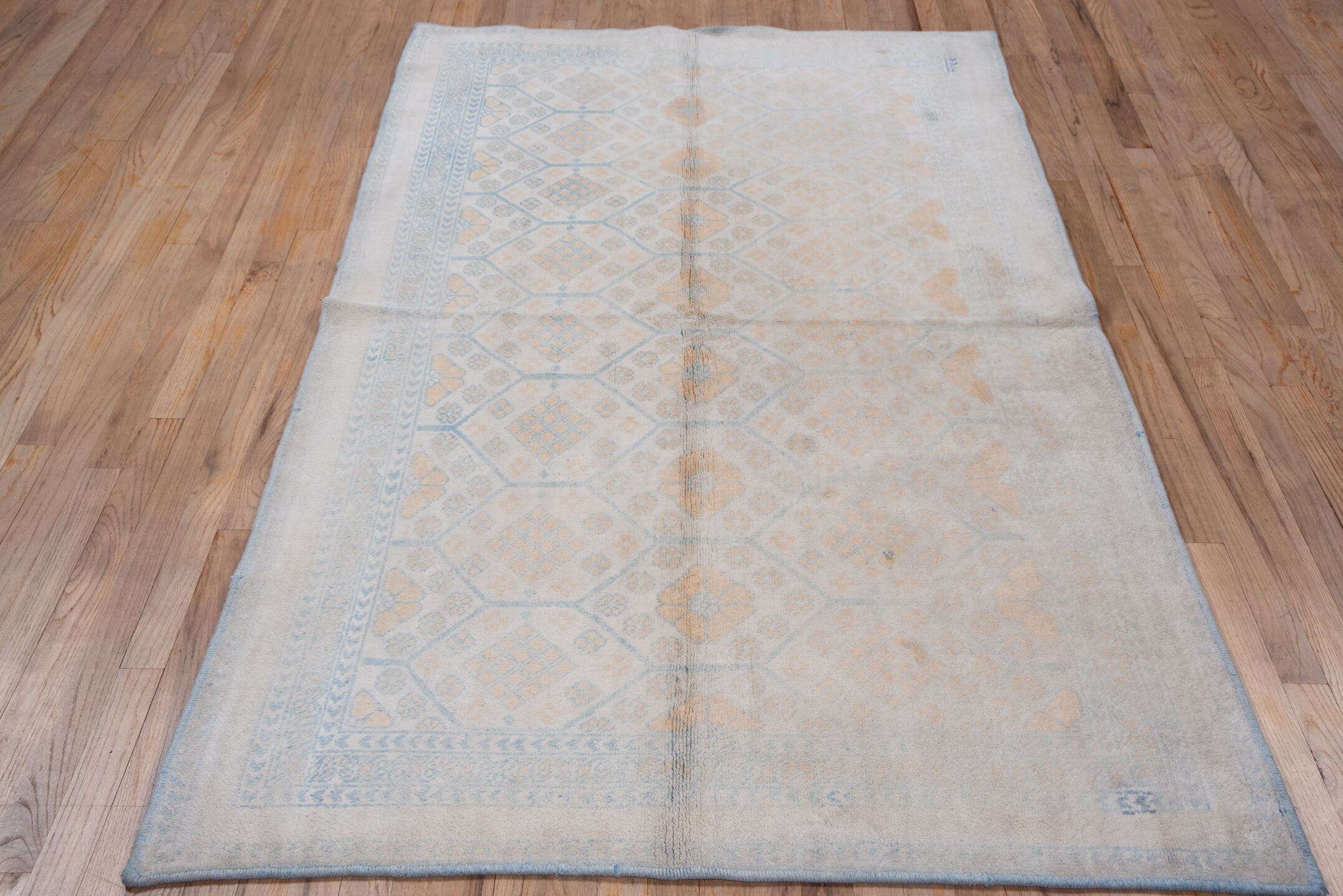 4' x 7' one-of-a-kind handmade vintage Cotton Agra rug. Color palette: ivory, pale blue, peach, sky blue, cream, taupe