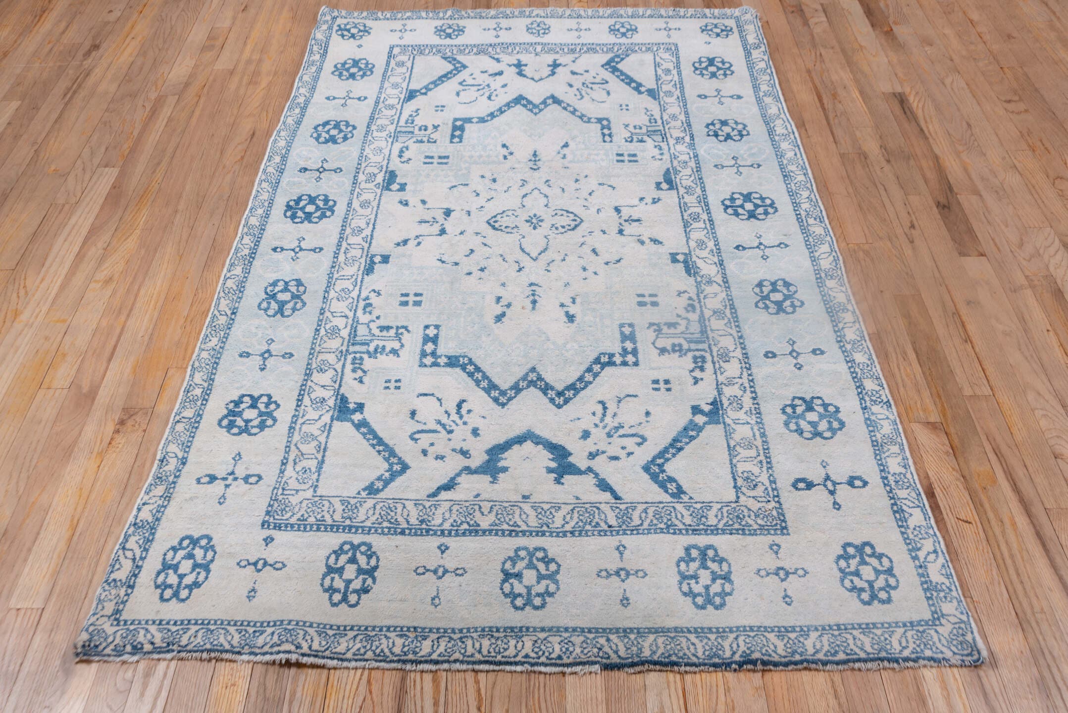 4' x 7' one-of-a-kind handmade vintage Cotton Agra rug. Color palette: ivory, sky blue, powder blue, denim blue, light blue