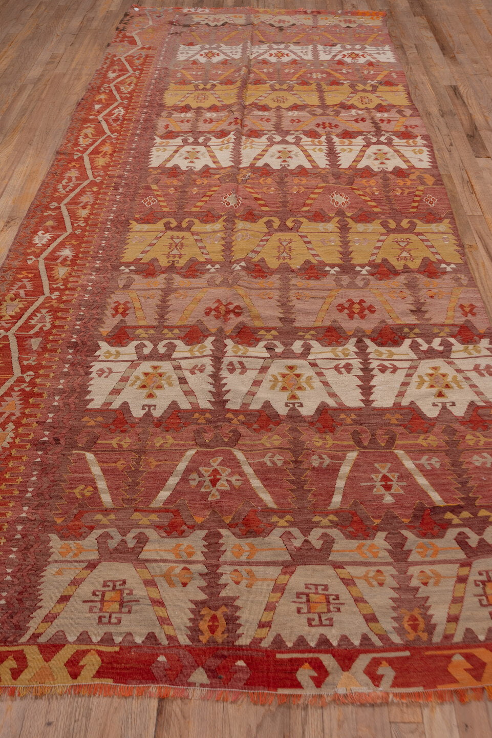 4' x 12' one-of-a-kind handmade vintage Kilim runner rug. Color palette: brown, red, redwood