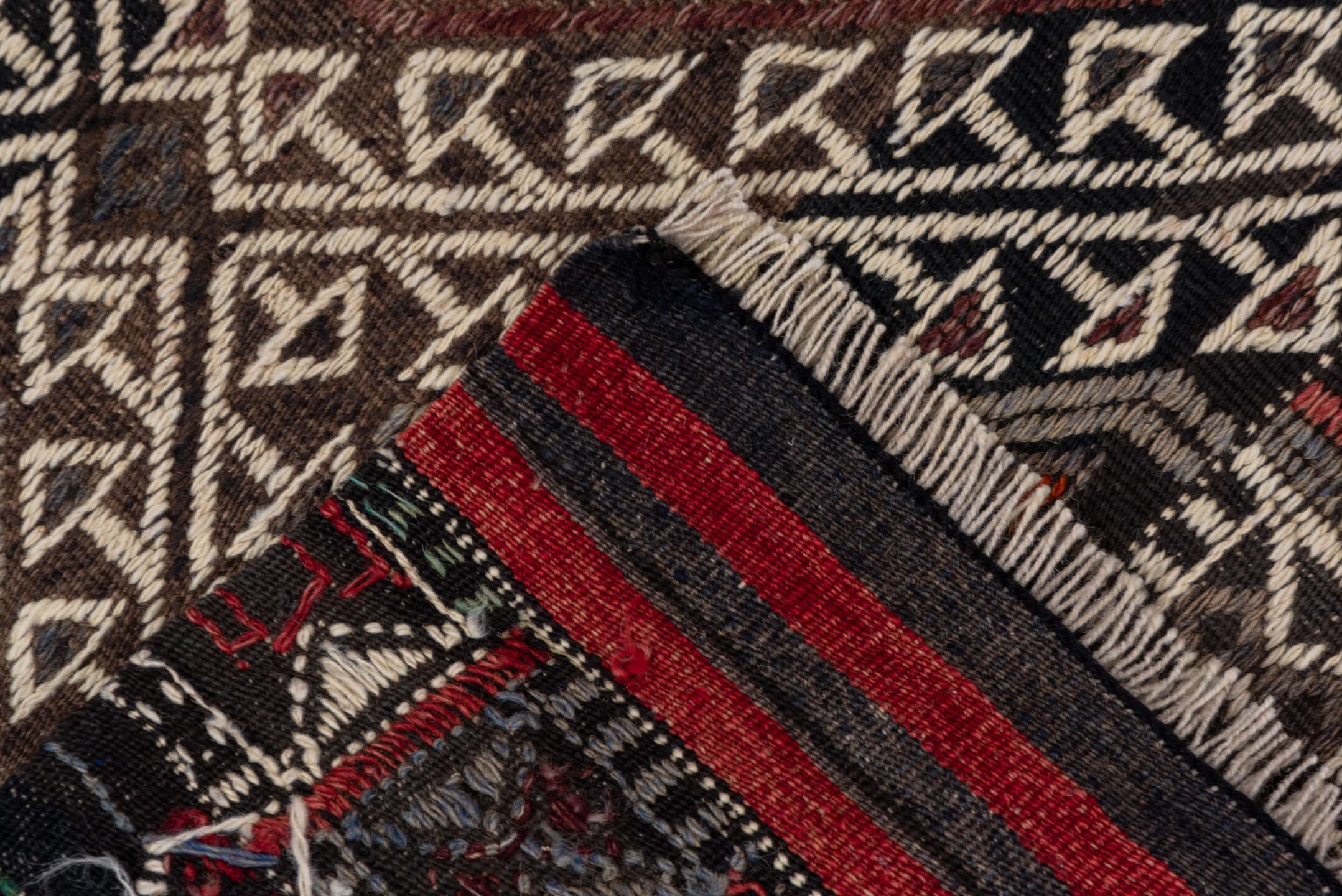 4' x 8' one-of-a-kind handmade vintage Jijim rug. Color palette: charcoal, ivory, rust, olive, taupe, rose, slate, gray