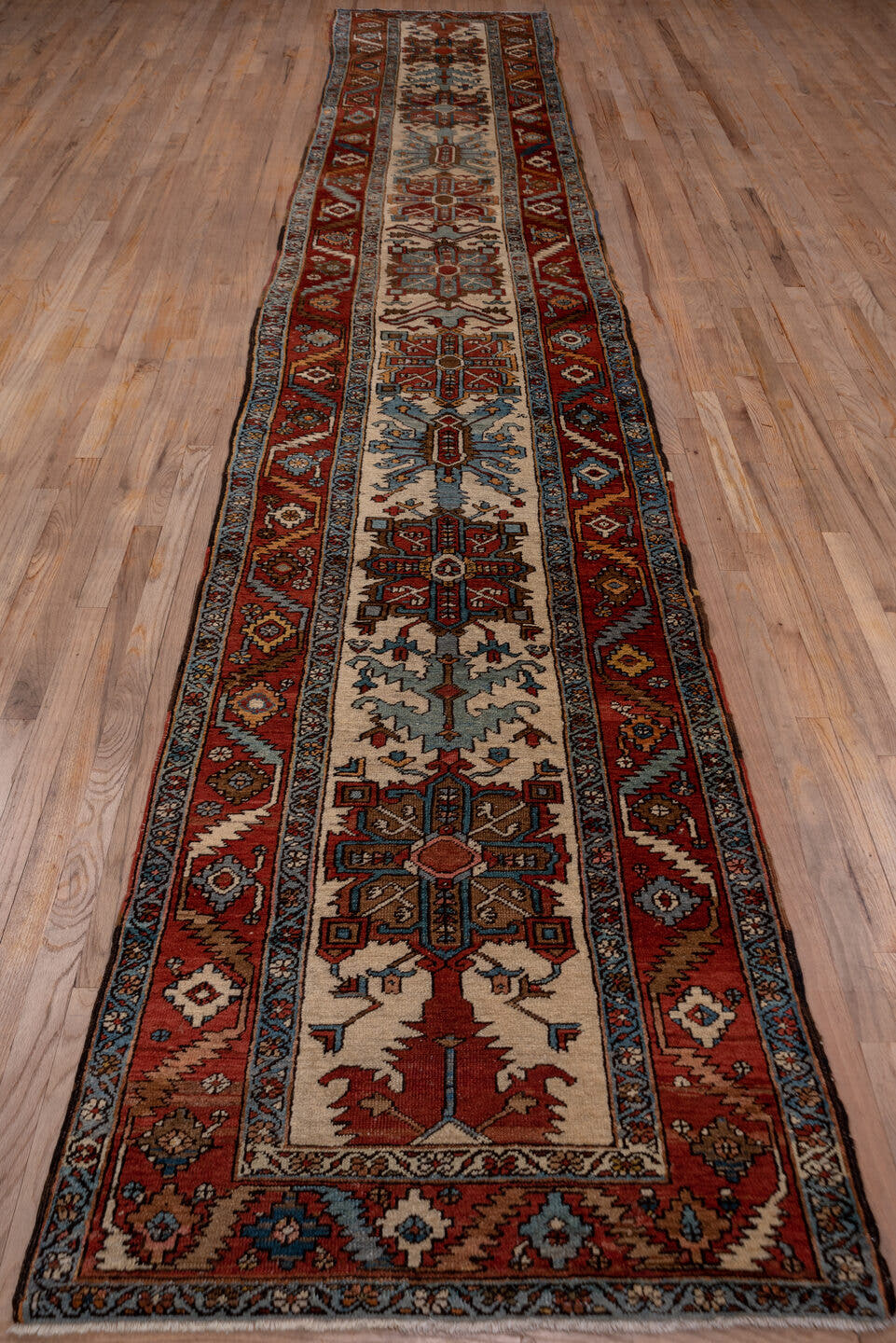 3' x 17' one-of-a-kind handmade vintage Serapi runner rug. Color palette: rust, ivory, sky blue, navy, camel, brown