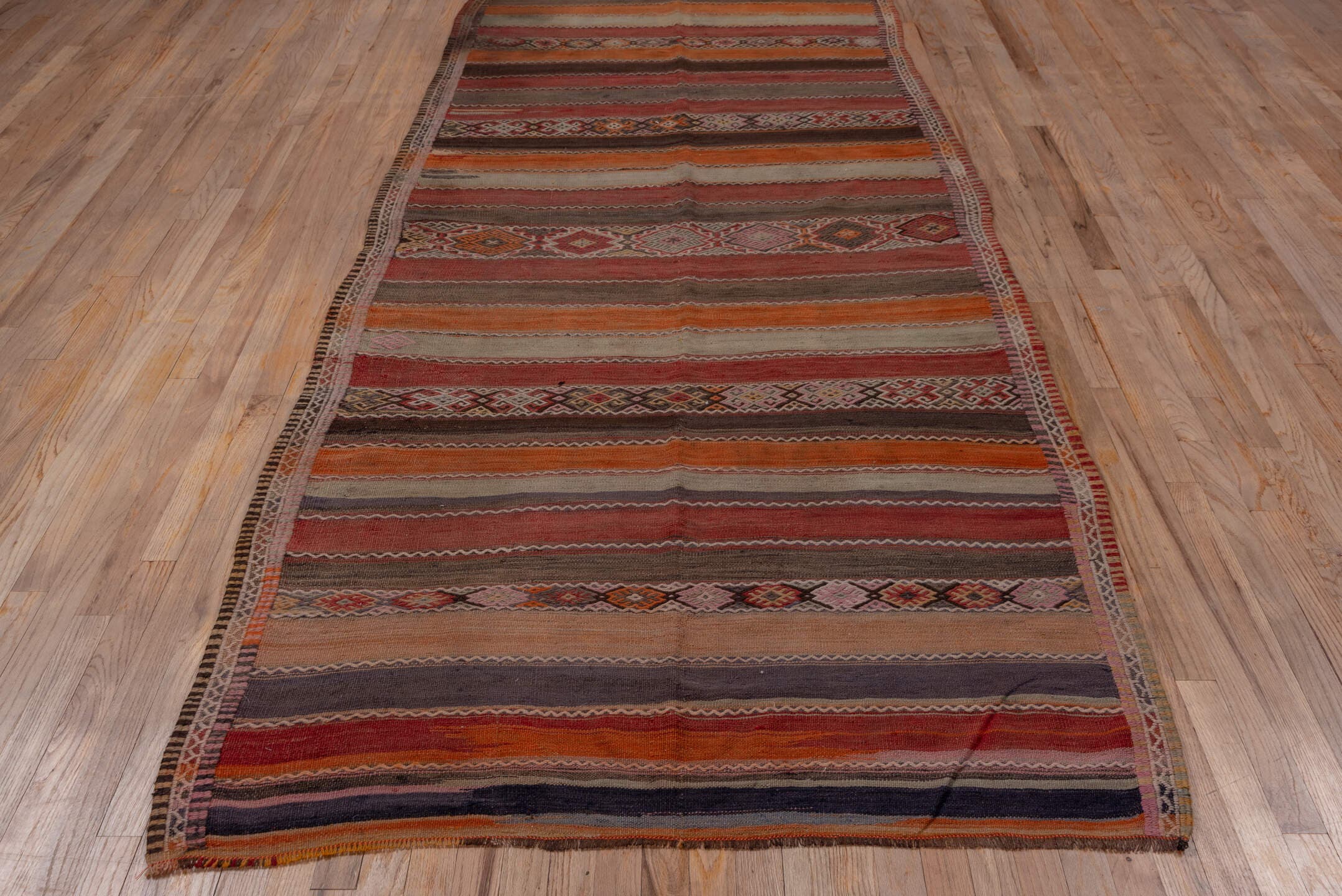 4' x 10' one-of-a-kind handmade vintage Jijim runner rug. Color palette: rust, rose, taupe, brown, charcoal, terracotta