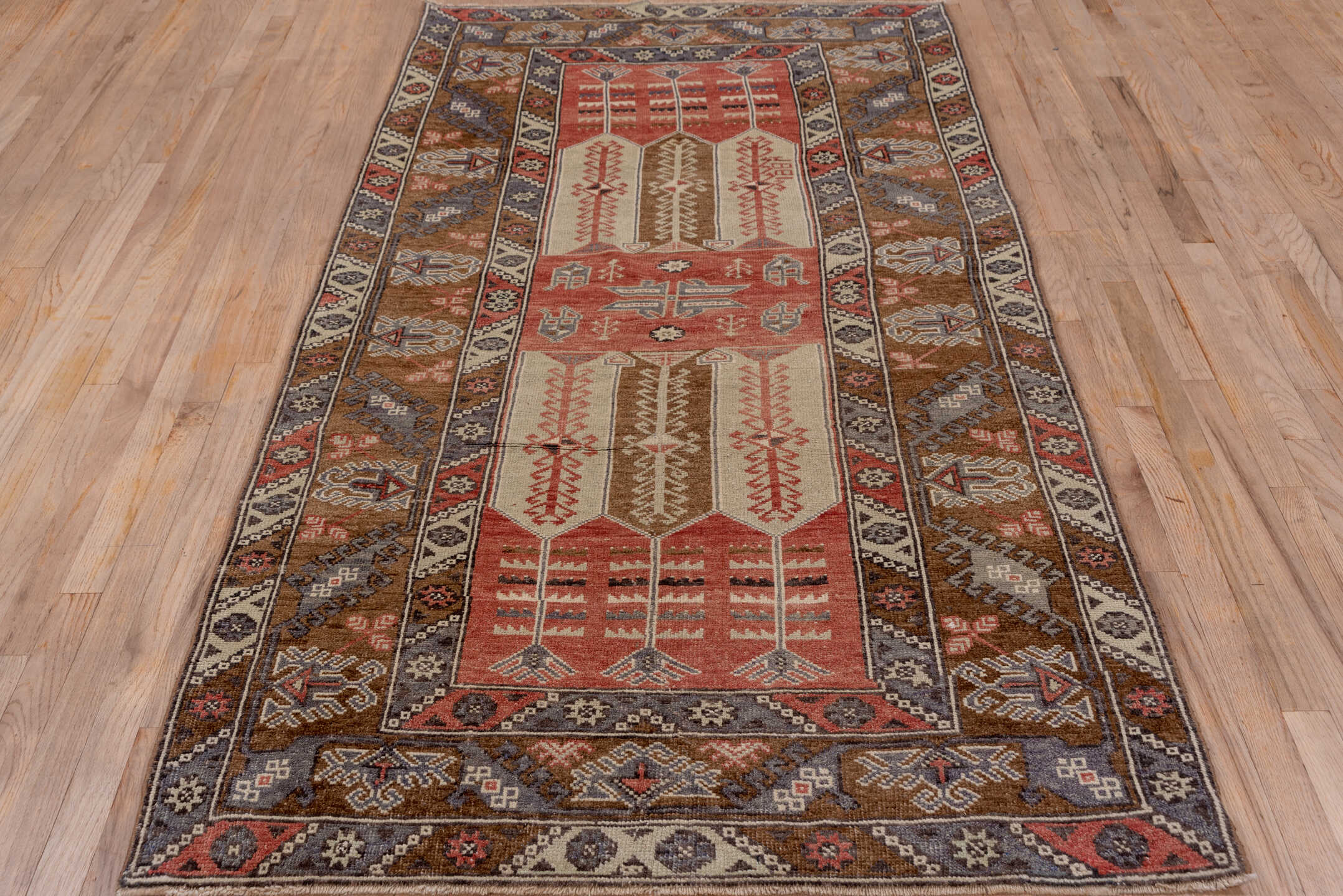 4' x 8' one-of-a-kind handmade vintage Konya runner rug. Color palette: brown, gray, pink, red