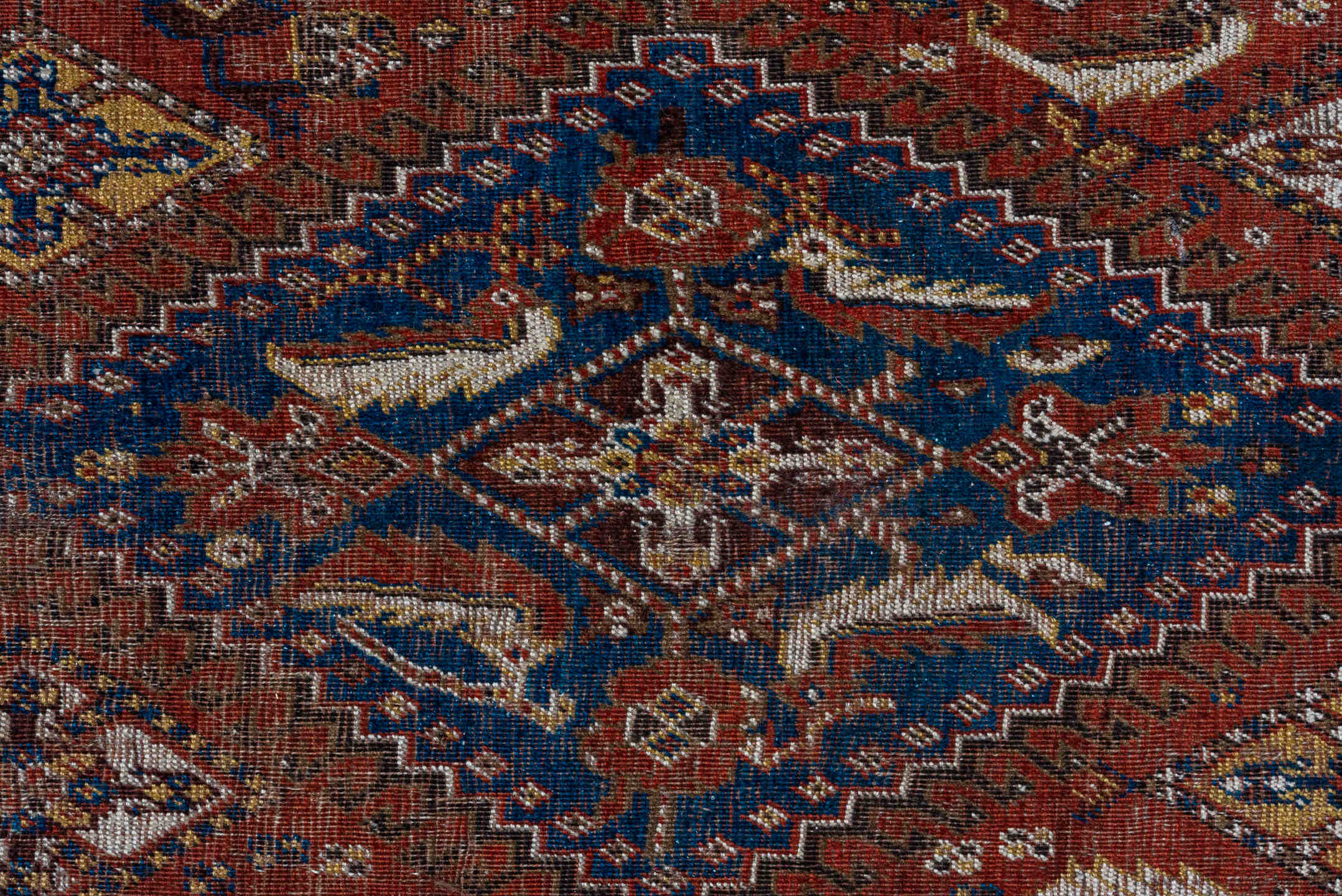 5' x 9' one-of-a-kind handmade antique Qashqai medium size rug. Color palette: rust, indigo, ivory, walnut, camel, navy