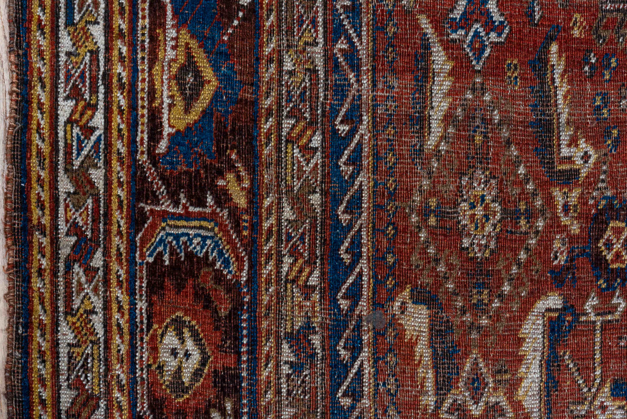 5' x 9' one-of-a-kind handmade antique Qashqai medium size rug. Color palette: rust, indigo, ivory, walnut, camel, navy
