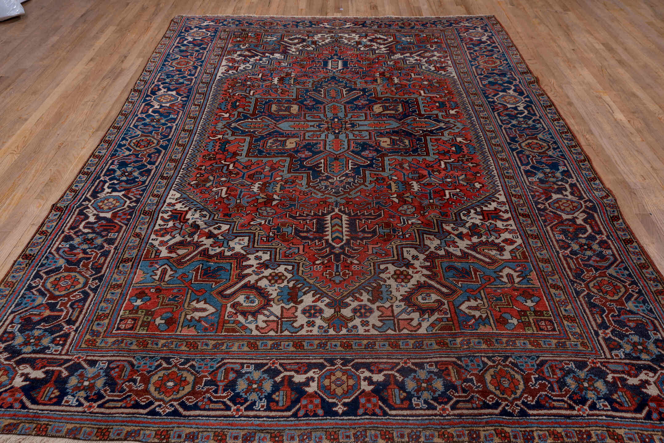 8' x 11' one-of-a-kind handmade antique Heriz large size rug. Color palette: rust, navy, ivory, sky blue, slate, camel