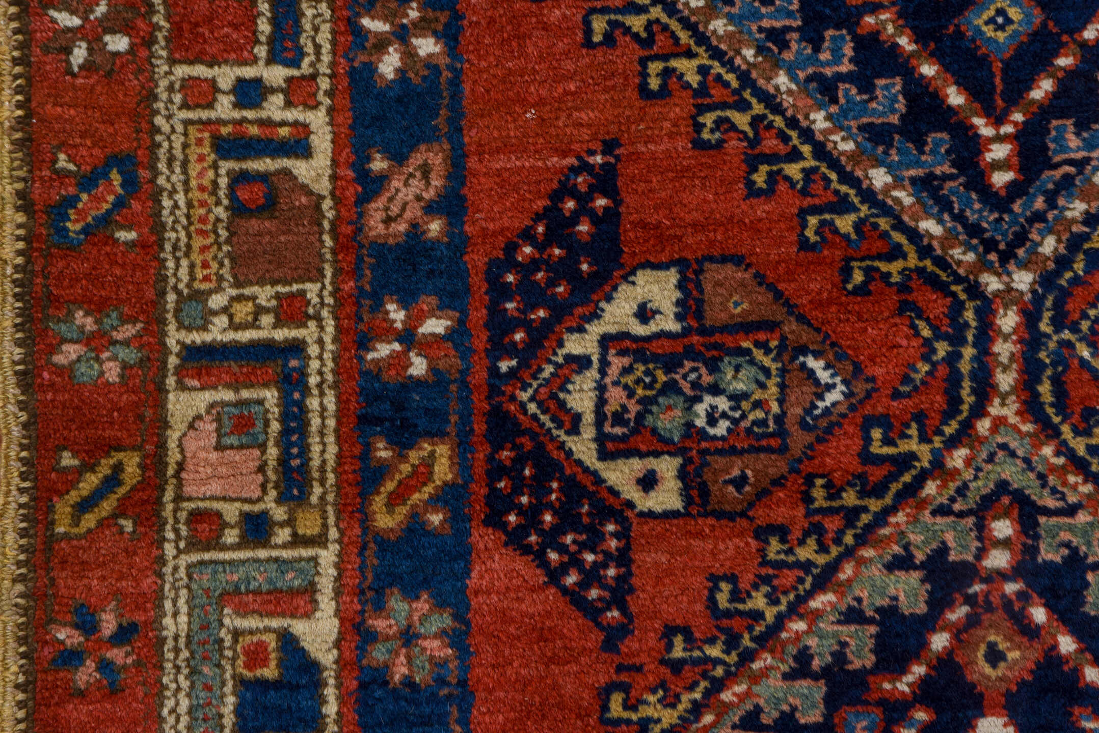 3' x 9' one-of-a-kind handmade vintage Heriz runner rug. Color palette: blue, brown, gray, maroon, pink, red, redwood