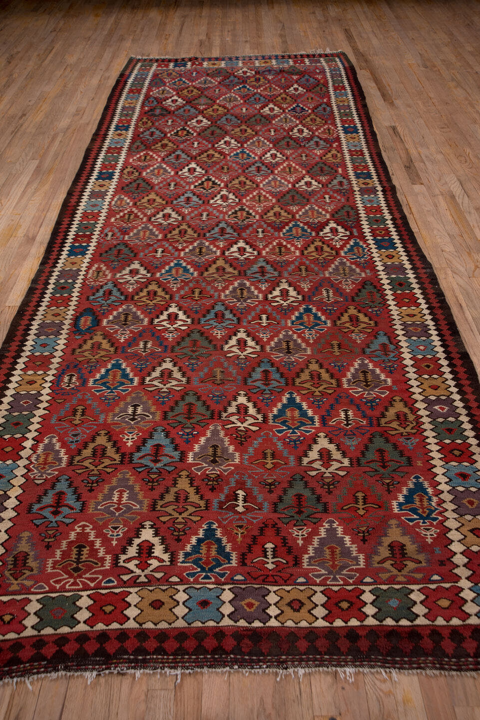 5' x 13' one-of-a-kind handmade antique Kilim rug. Color palette: rust, ivory, indigo, camel, charcoal, sky blue, burgundy