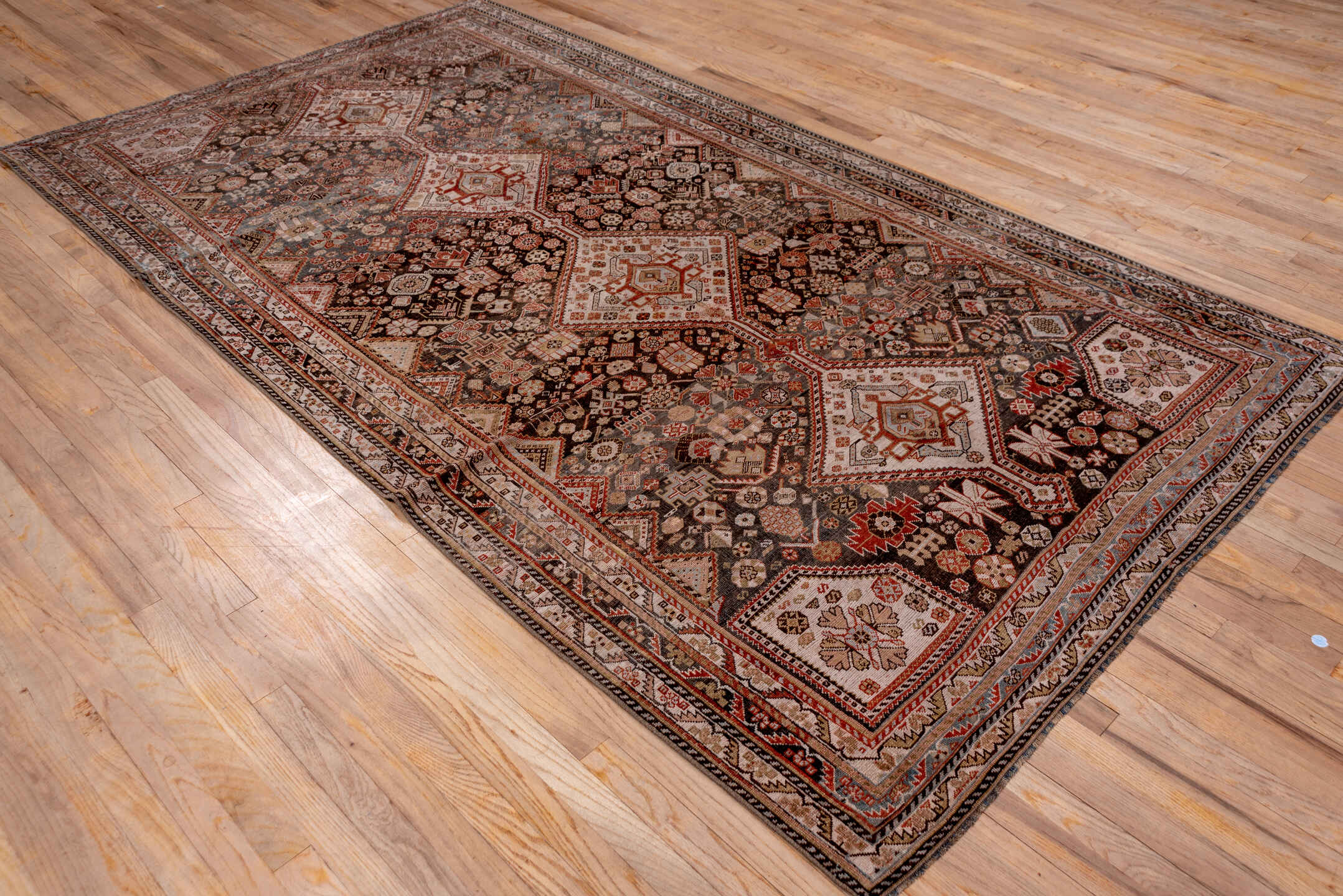 5' x 10' one-of-a-kind handmade antique Qashqai medium size rug. Color palette: ivory, charcoal, rust, slate, taupe, camel