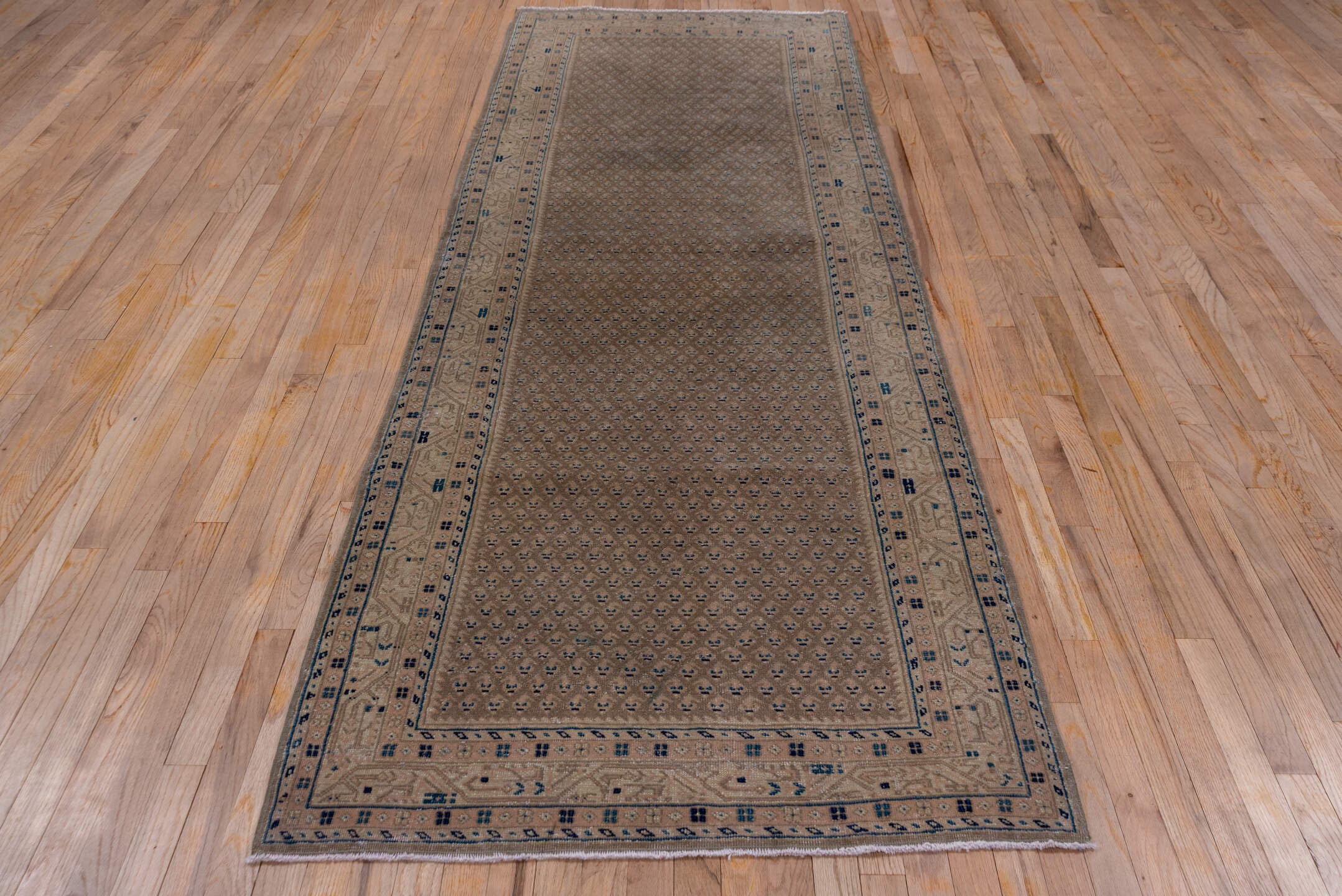 3' x 10' one-of-a-kind handmade vintage Mahal runner rug. Color palette: taupe, brown, beige, indigo, ivory, camel, gray