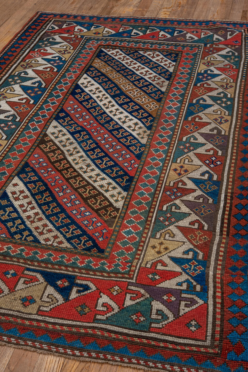 3' x 6' one-of-a-kind handmade antique Kazak small size rug. Color palette: ivory, navy, turquoise, rust, camel, terracotta
