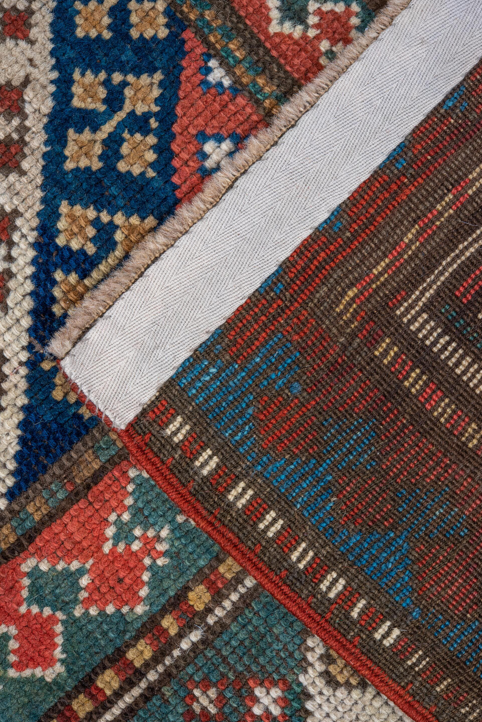 3' x 6' one-of-a-kind handmade antique Kazak small size rug. Color palette: ivory, navy, turquoise, rust, camel, terracotta