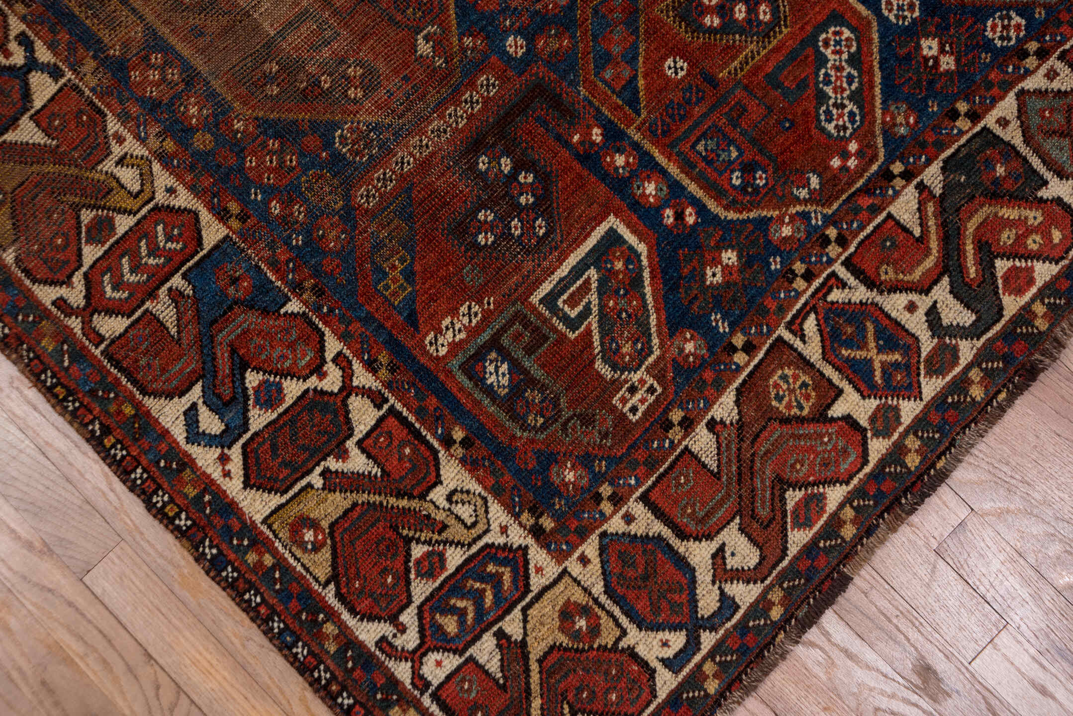 7' x 9' one-of-a-kind handmade antique Shiraz rug. Color palette: rust, indigo, ivory, brick, camel, navy, brown, terracotta