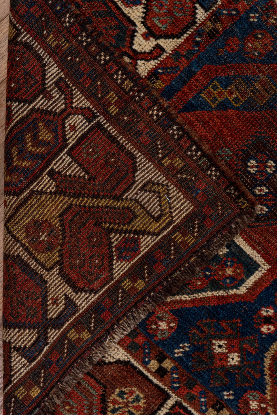 7' x 9' one-of-a-kind handmade antique Shiraz rug. Color palette: rust, indigo, ivory, brick, camel, navy, brown, terracotta