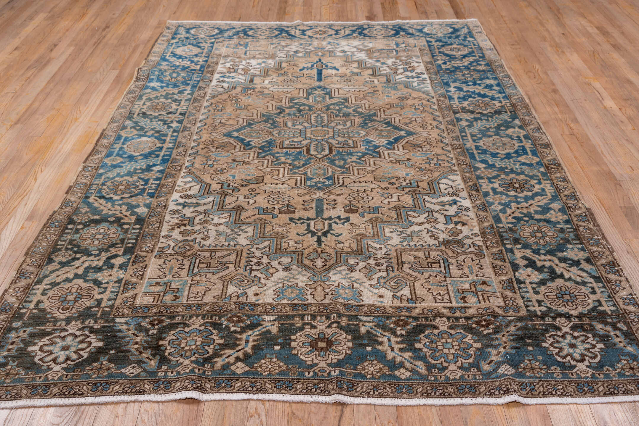 6' x 9' one-of-a-kind handmade antique Heriz medium size rug. Color palette: ivory, blue, taupe, brown, sky blue, charcoal