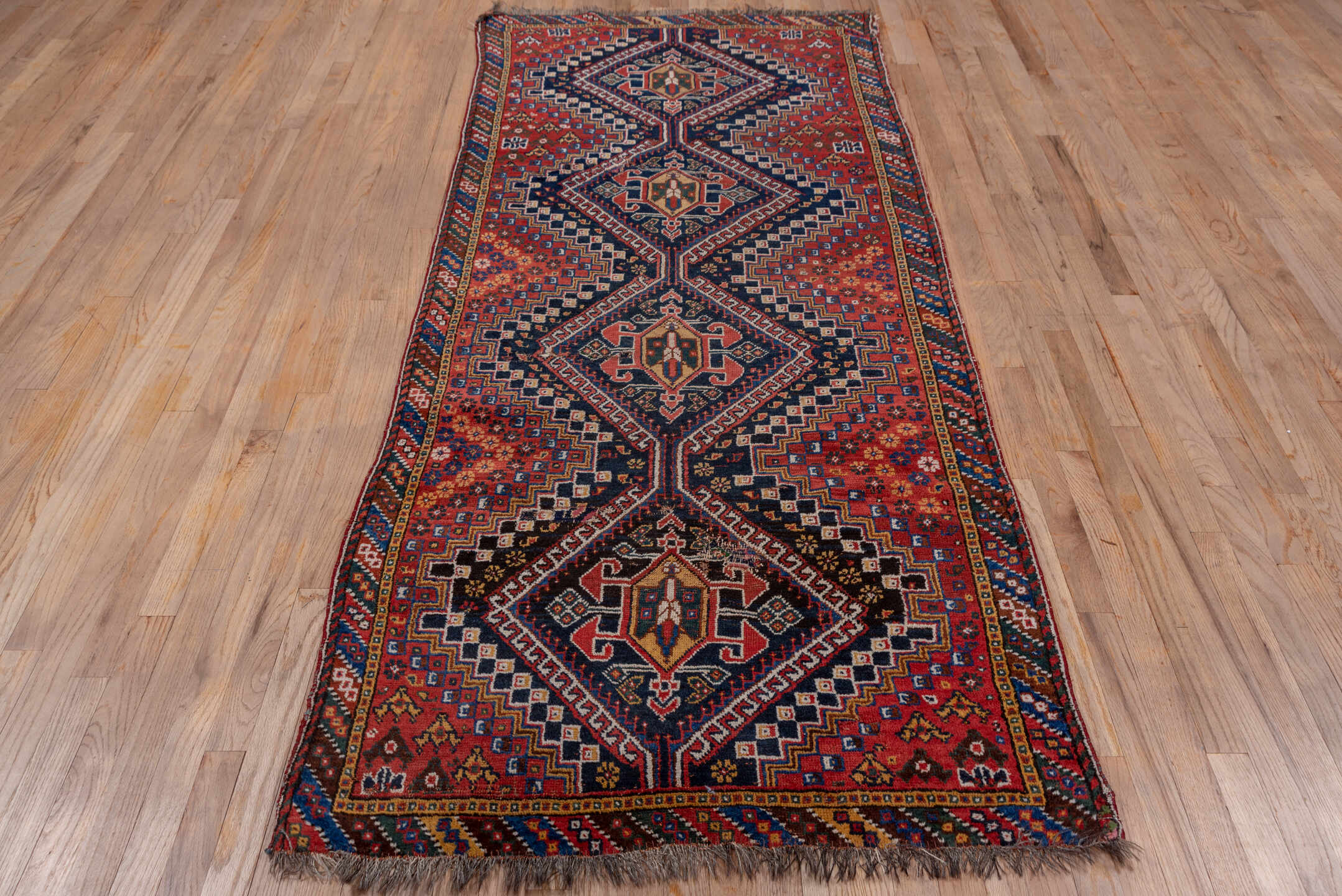 3' x 9' one-of-a-kind handmade vintage Shiraz runner rug. Color palette: black, blue, brown, fiord, gray, pink, red