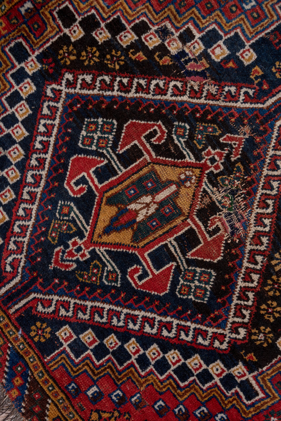 3' x 9' one-of-a-kind handmade antique Shiraz runner rug. Color palette: rust, navy, ivory, indigo, camel, gold, crimson