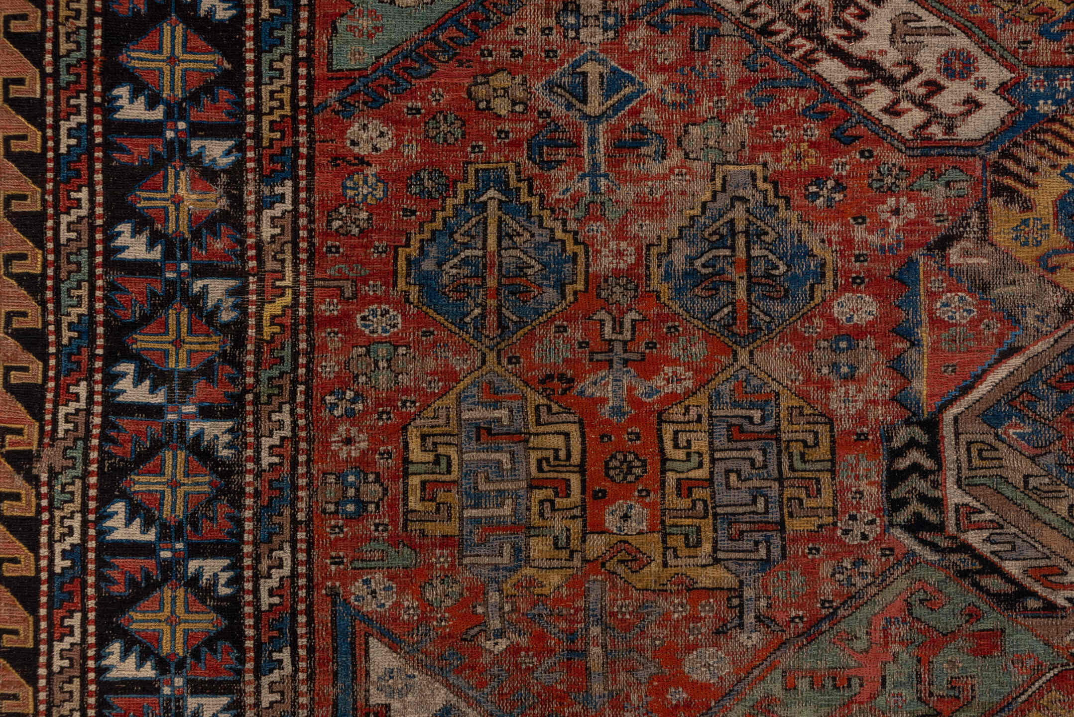 6' x 10' one-of-a-kind handmade antique Sumak large size rug. Color palette: rust, indigo, ivory, camel, aqua, charcoal