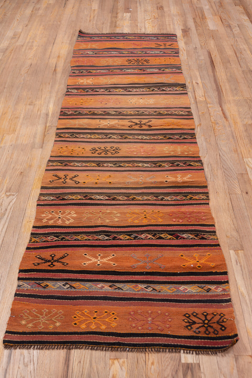 2' x 8' one-of-a-kind handmade vintage Kilim runner rug. Color palette: terra cotta, rust, charcoal, ivory, gold, rose