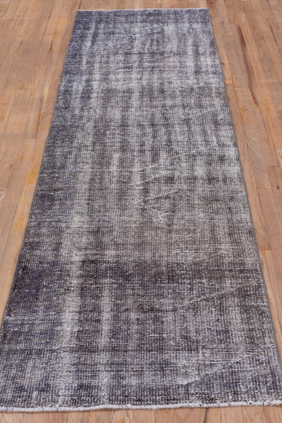 2' x 9' one-of-a-kind handmade vintage Overdyed runner rug. Color palette: taupe, charcoal, gray, ivory, beige, black