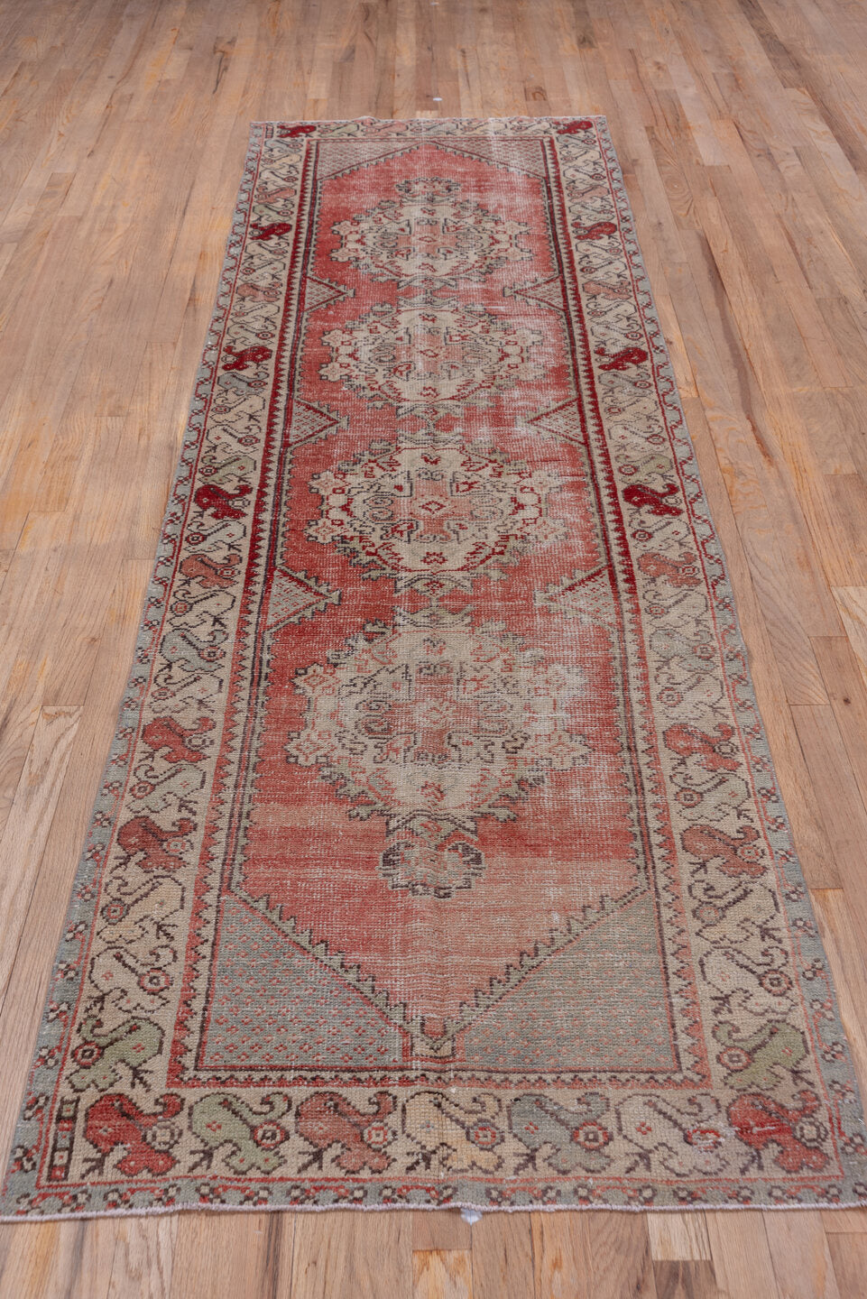 2' x 10' one-of-a-kind handmade vintage Oushak runner rug. Color palette: brown, gray, pink, red