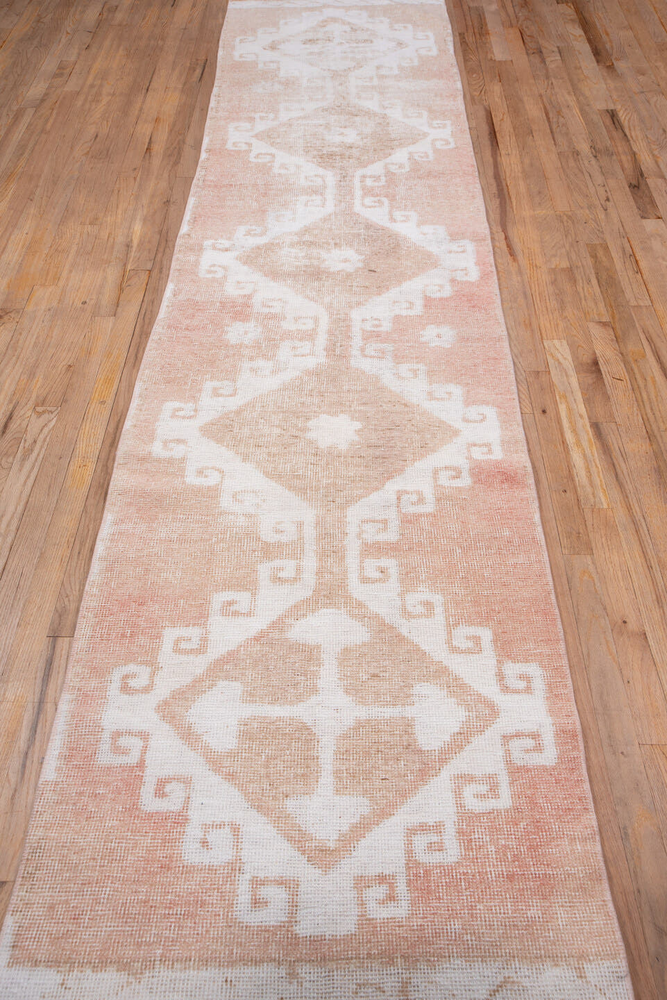2' x 12' one-of-a-kind handmade vintage Oushak runner rug. Color palette: blush, ivory, peach, beige, pink, terracotta