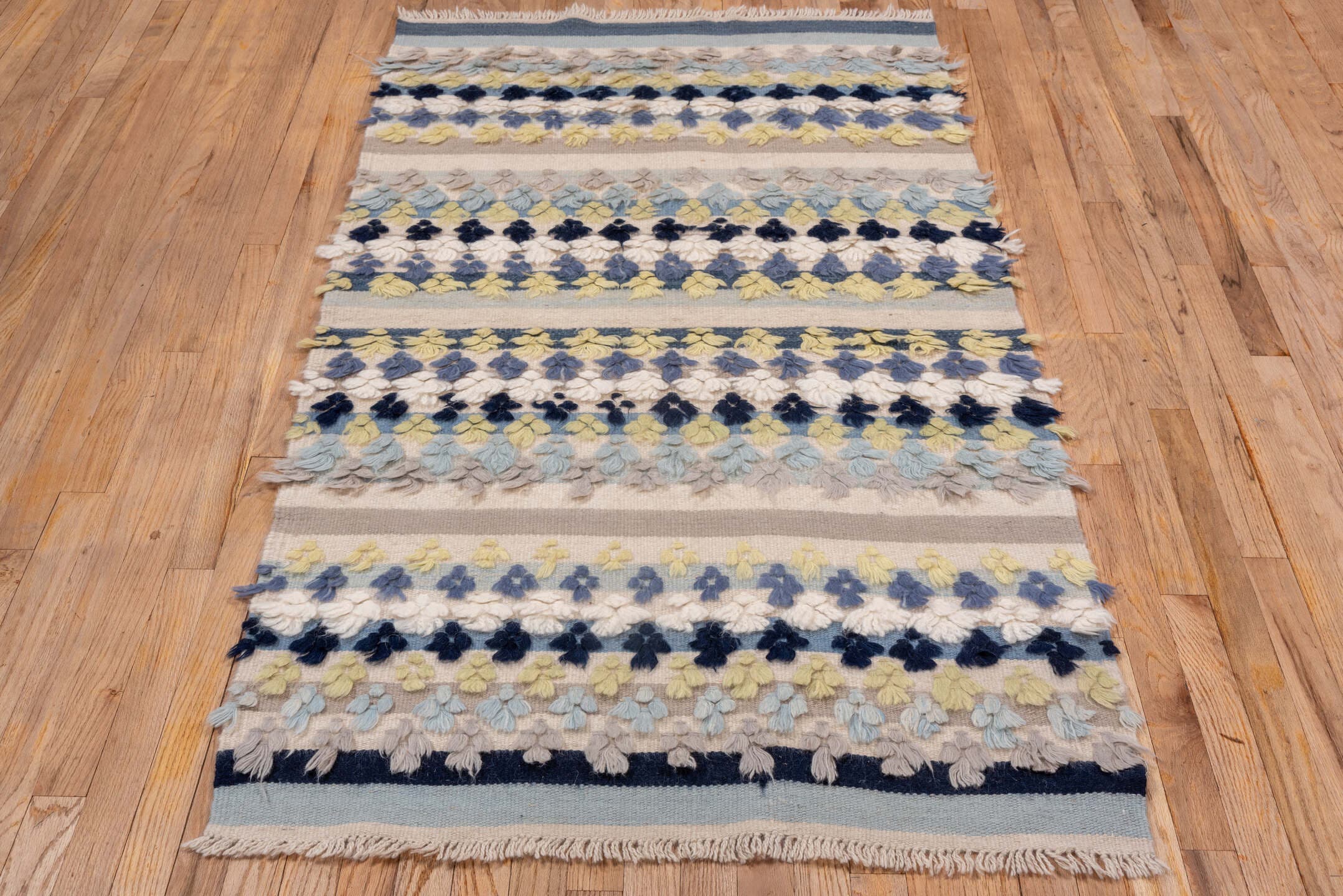 3' x 6' one-of-a-kind handmade vintage Tulu small size rug. Color palette: ivory, pale blue, taupe, navy, butter yellow