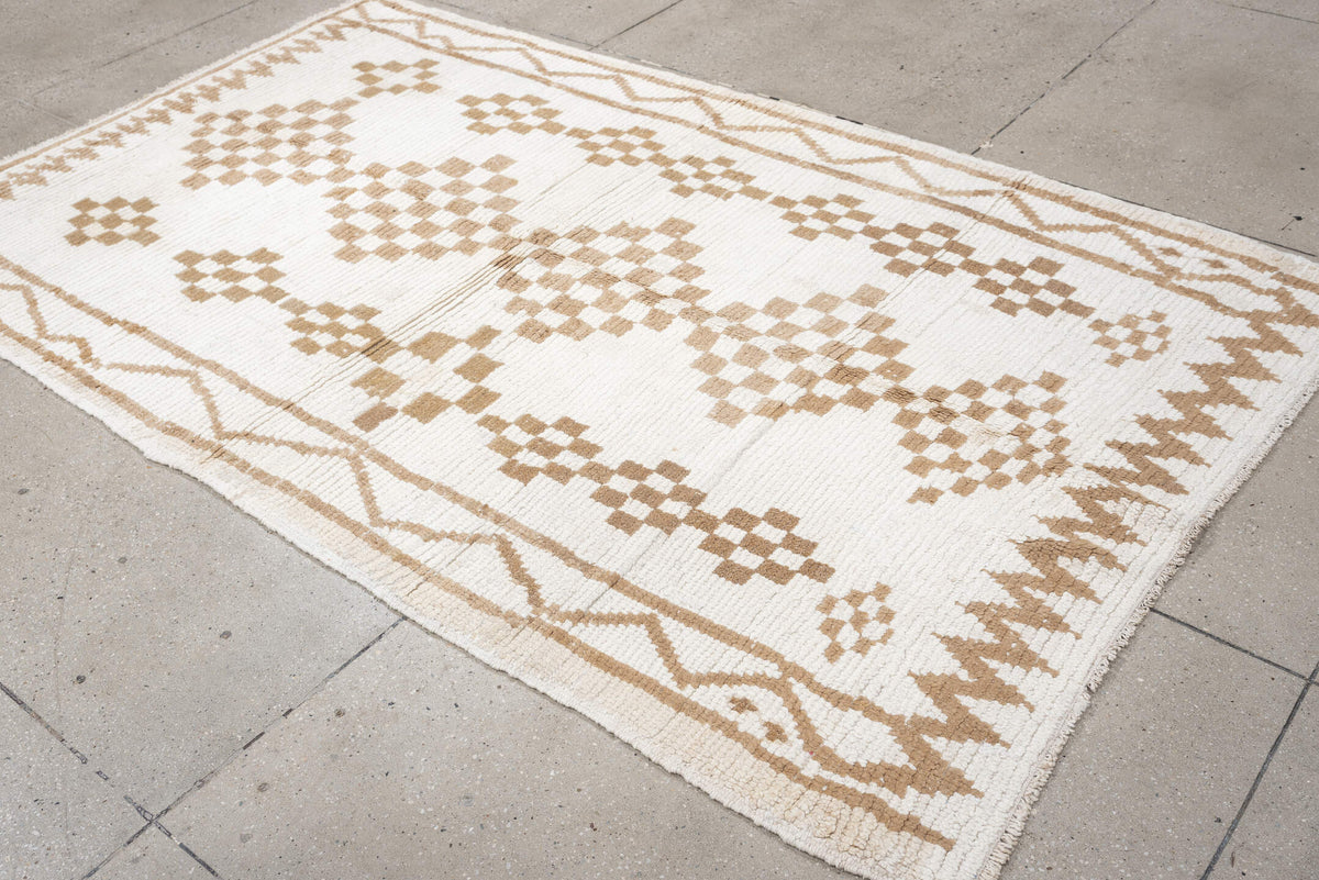 4' x 8' one-of-a-kind handmade vintage Moroccan medium size rug. Color palette: ivory, camel, cream, tan, beige