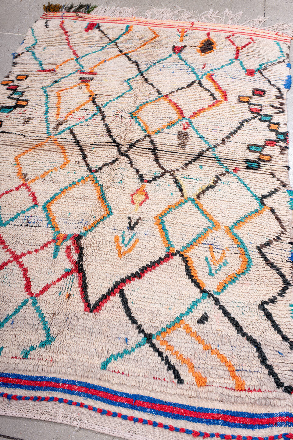 4' x 6' one-of-a-kind handmade vintage Moroccan small size rug. Color palette: ivory, turquoise, charcoal, orange, red, blue