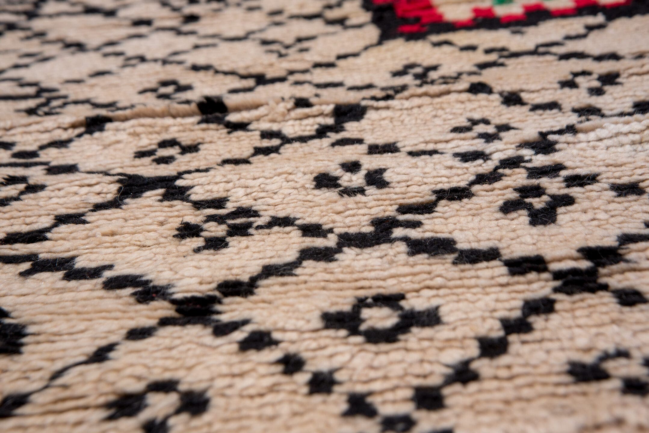 5' x 7' one-of-a-kind handmade antique Moroccan rug. Color palette: ivory, black, crimson, green, gold, rose, red, pink