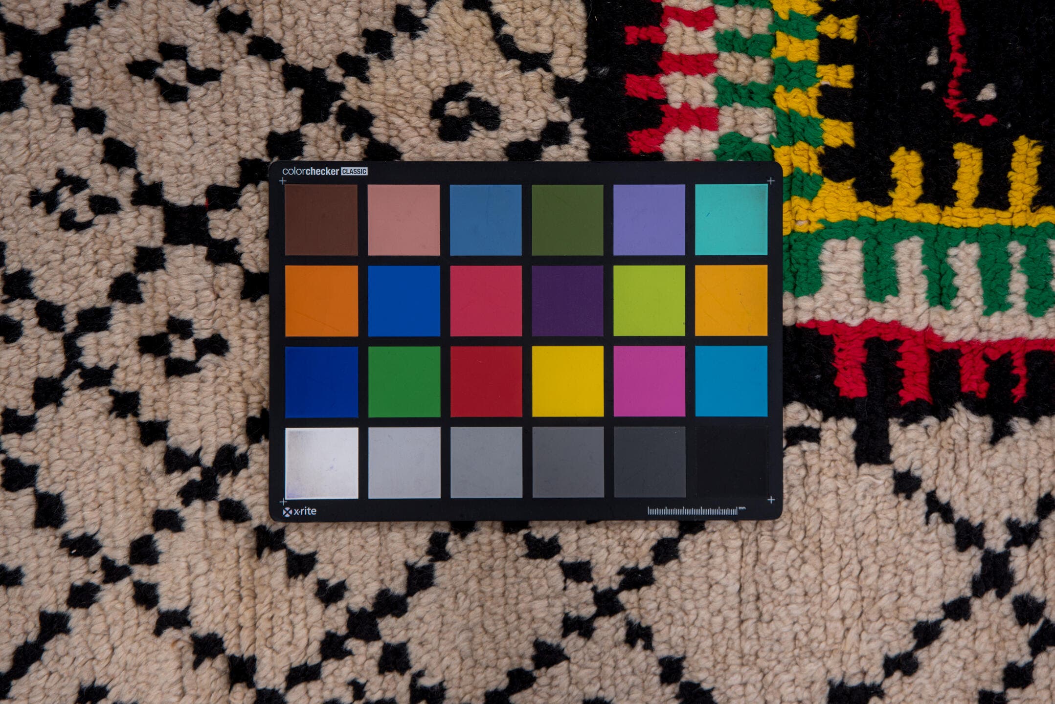 5' x 7' one-of-a-kind handmade antique Moroccan rug. Color palette: ivory, black, crimson, green, gold, rose, red, pink