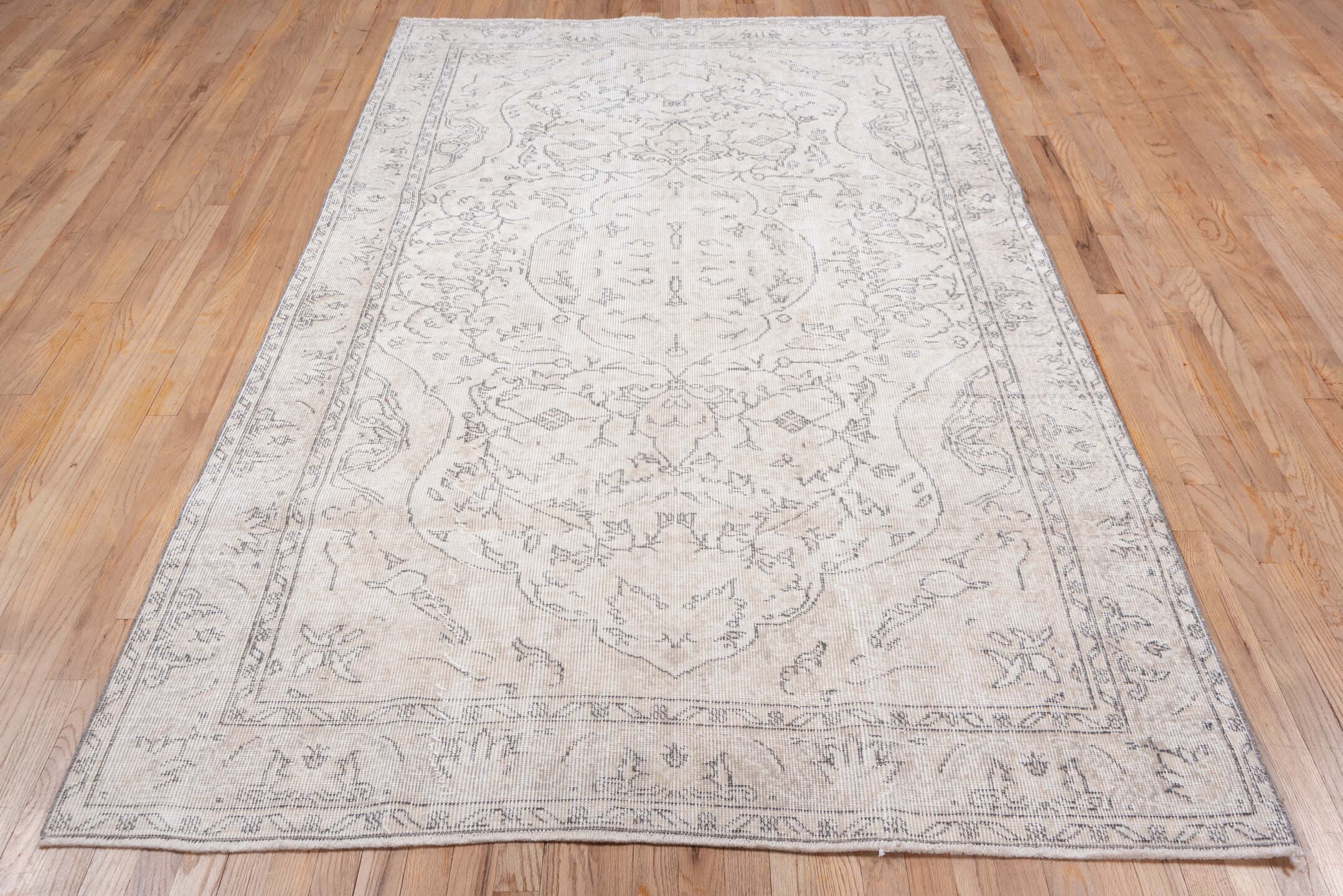 5' x 9' one-of-a-kind handmade antique Sparta medium size rug. Color palette: ivory, taupe, beige, cream, pale gray, gray